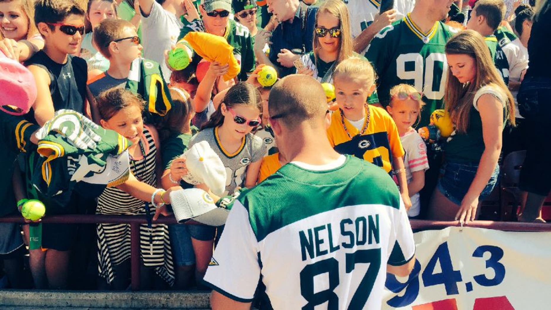 Green Bay Packers receiver Jordy Nelson signs autographs after his annual charity softball game.