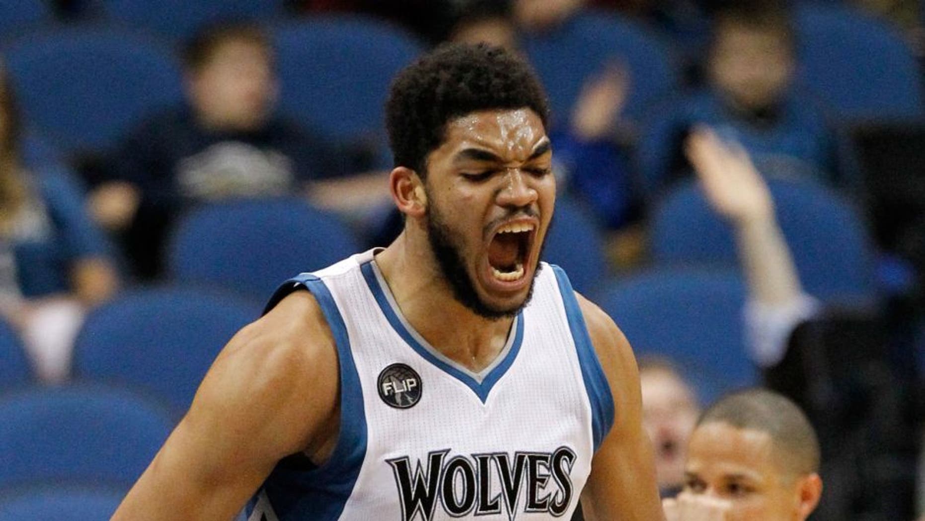 Minnesota Timberwolves center Karl-Anthony Towns reacts after making a shot.