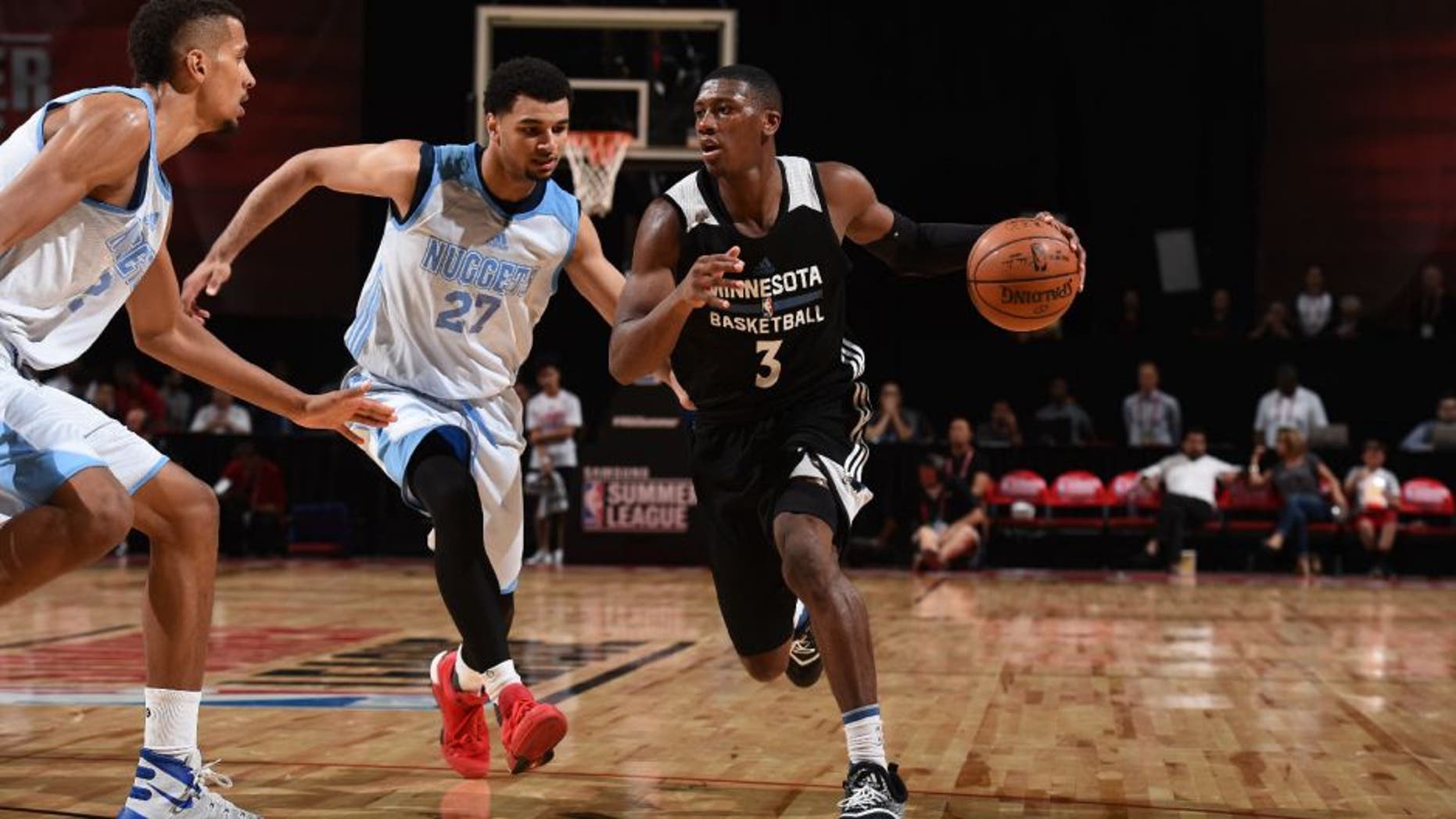 Kris Dunn of the Minnesota Timberwolves drives to the basket against the Denver Nuggets during the 2016 Las Vegas Summer League.