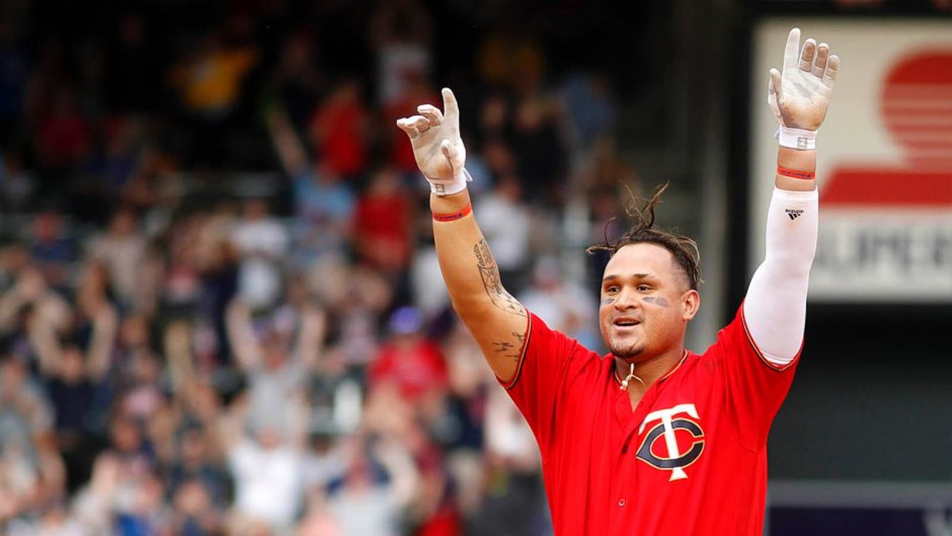 The Minnesota Twins' Oswaldo Arcia celebrates after driving in the winning run against the Los Angeles Angels in the 12th inning Sunday April 17, 2016, in Minneapolis.