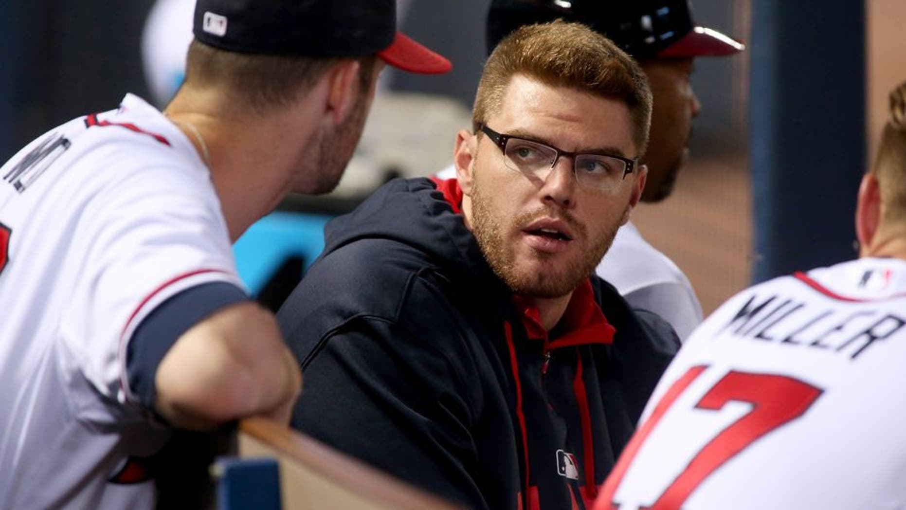 Jul 17, 2015; Atlanta, GA, USA; Atlanta Braves first baseman Freddie Freeman (C) talks with starting pitcher Alex Wood (40) in the dugout in the fourth inning of their game against the Chicago Cubs at Turner Field. Mandatory Credit: Jason Getz-USA TODAY Sports