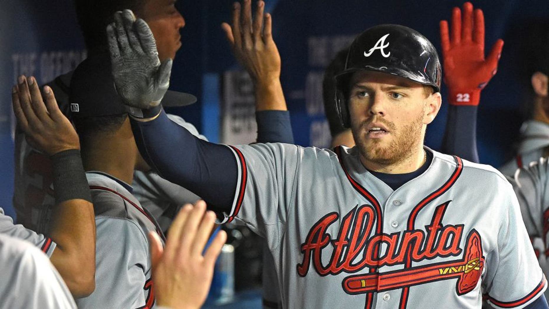 Apr 18, 2015; Toronto, Ontario, CAN; Atlanta Braves first baseman Freddie Freeman (5) is greeted by teammates after hitting a two-run home run against Toronto Blue Jays in the third inning at Rogers Centre. Mandatory Credit: Dan Hamilton-USA TODAY Sports
