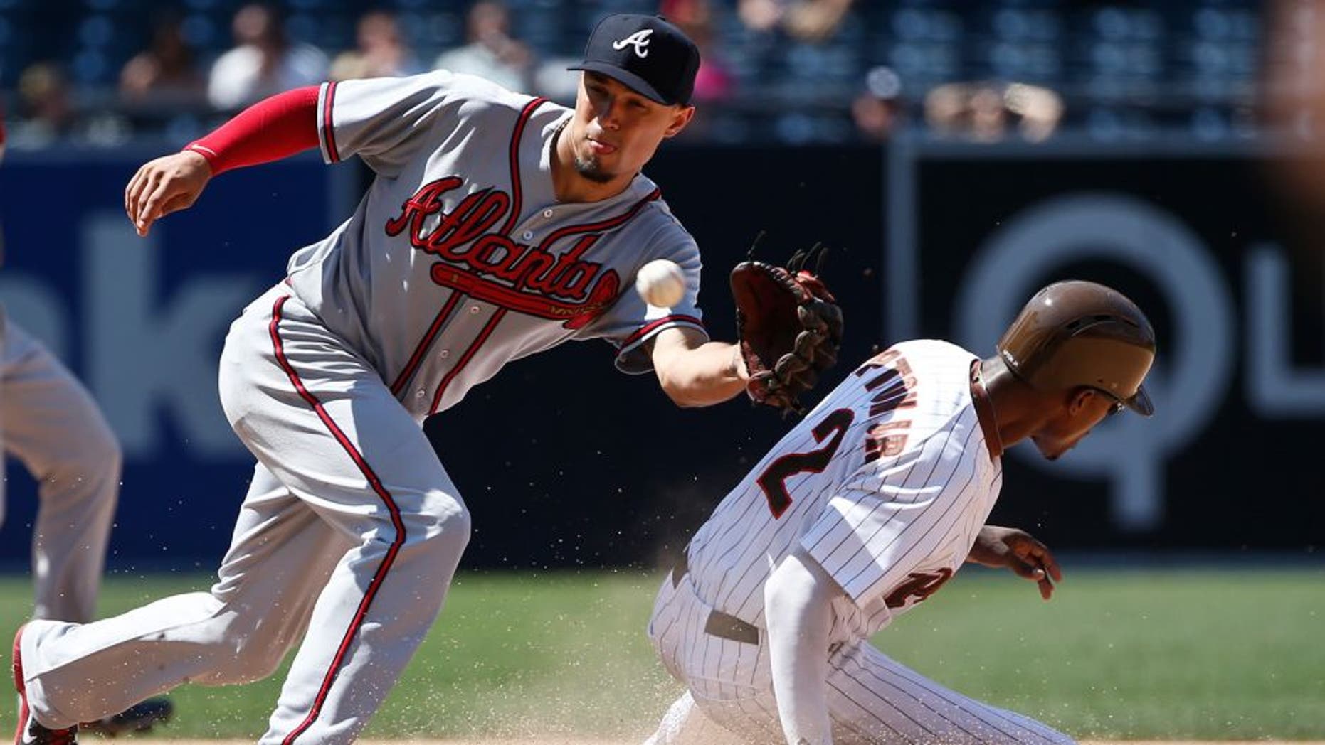 San Diego Padres' Melvin Upton Jr. beats the throw to Atlanta Braves second baseman Jace Peterson while stealing second during the seventh inning of a baseball game Wednesday, Aug. 19, 2015, in San Diego. (AP Photo/Lenny Ignelzi)