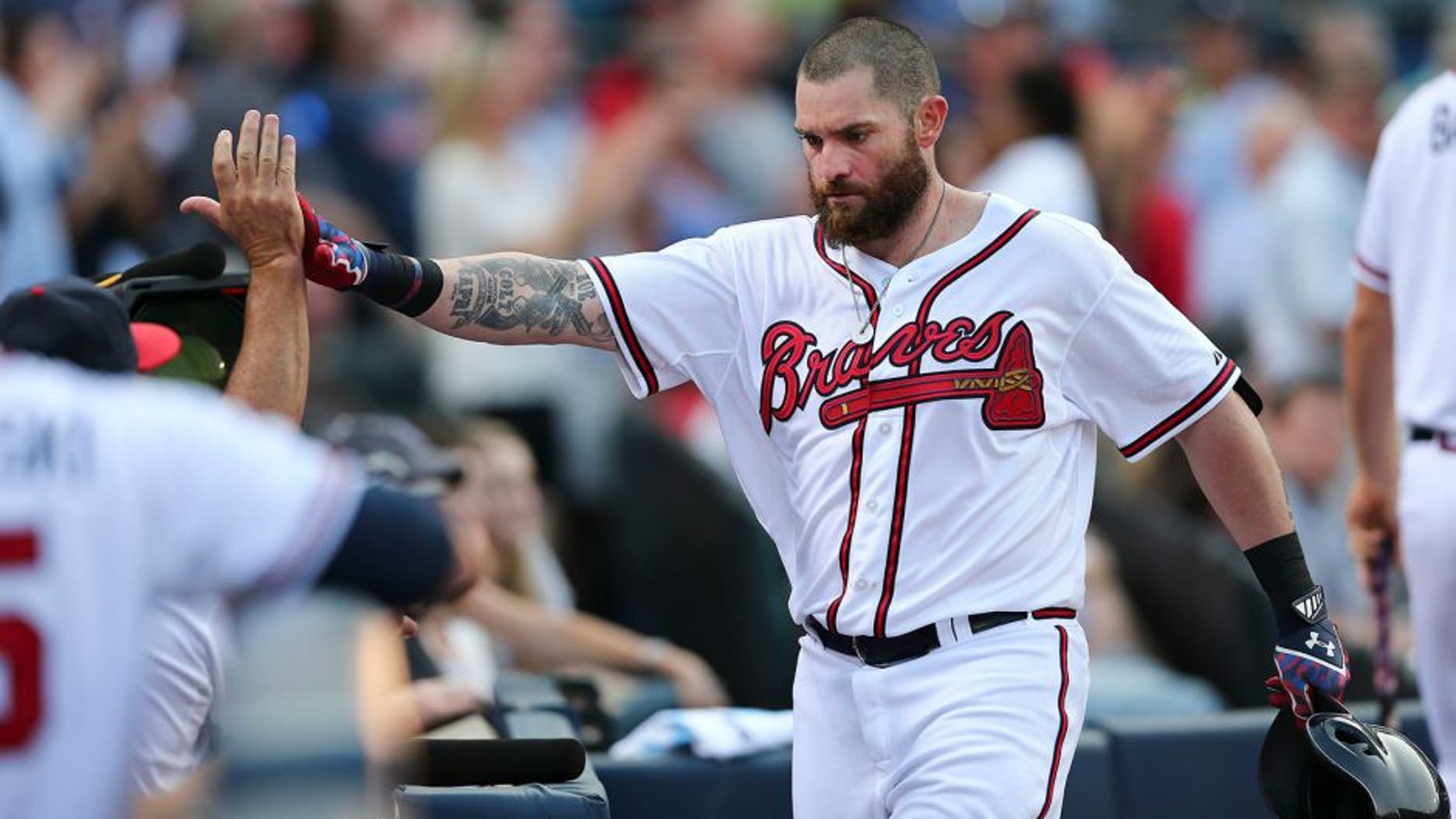 Atlanta Braves' Jonny Gomes celebrates after hitting a two-run home run in the first inning of a baseball game against the Colorado Rockies Monday, Aug. 24, 2015, in Atlanta. Atlanta won 5-3. (AP Photo/John Bazemore)