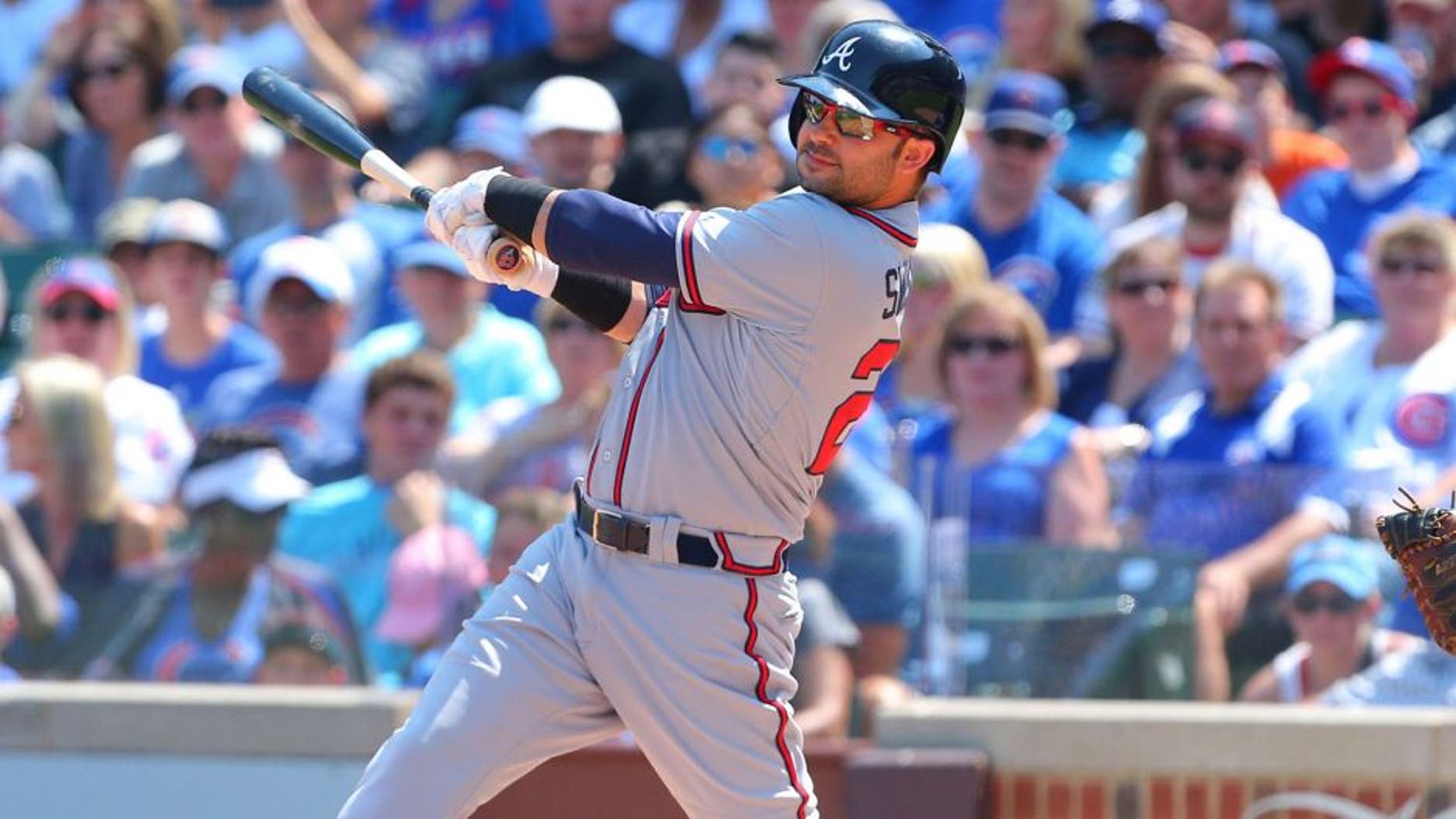 Aug 23, 2015; Chicago, IL, USA; Atlanta Braves first baseman Nick Swisher (23) hits a single during the first inning against the Chicago Cubs at Wrigley Field. Mandatory Credit: Dennis Wierzbicki-USA TODAY Sports