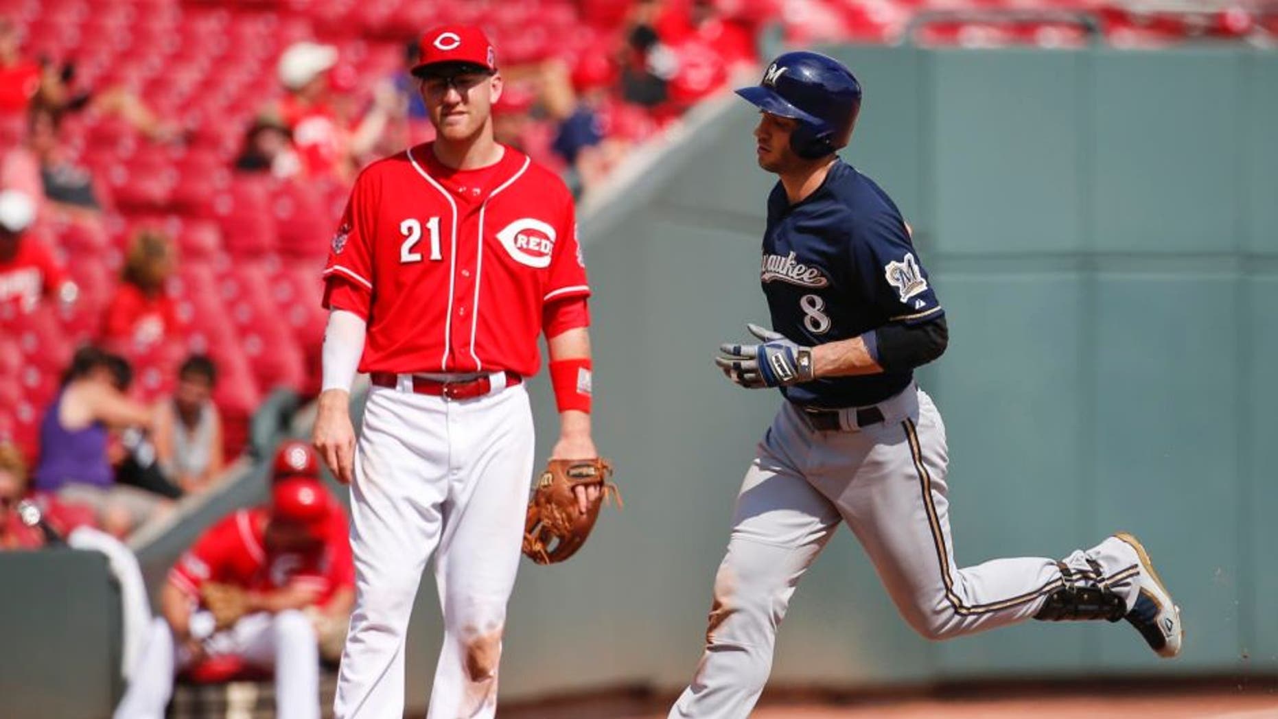 The Milwaukee Brewers' Ryan Braun rounds third after hitting a solo home run as Cincinnati Reds third baseman Todd Frazier looks on in the eighth inning Sunday, Sept. 6, 2015, in Cincinnati.