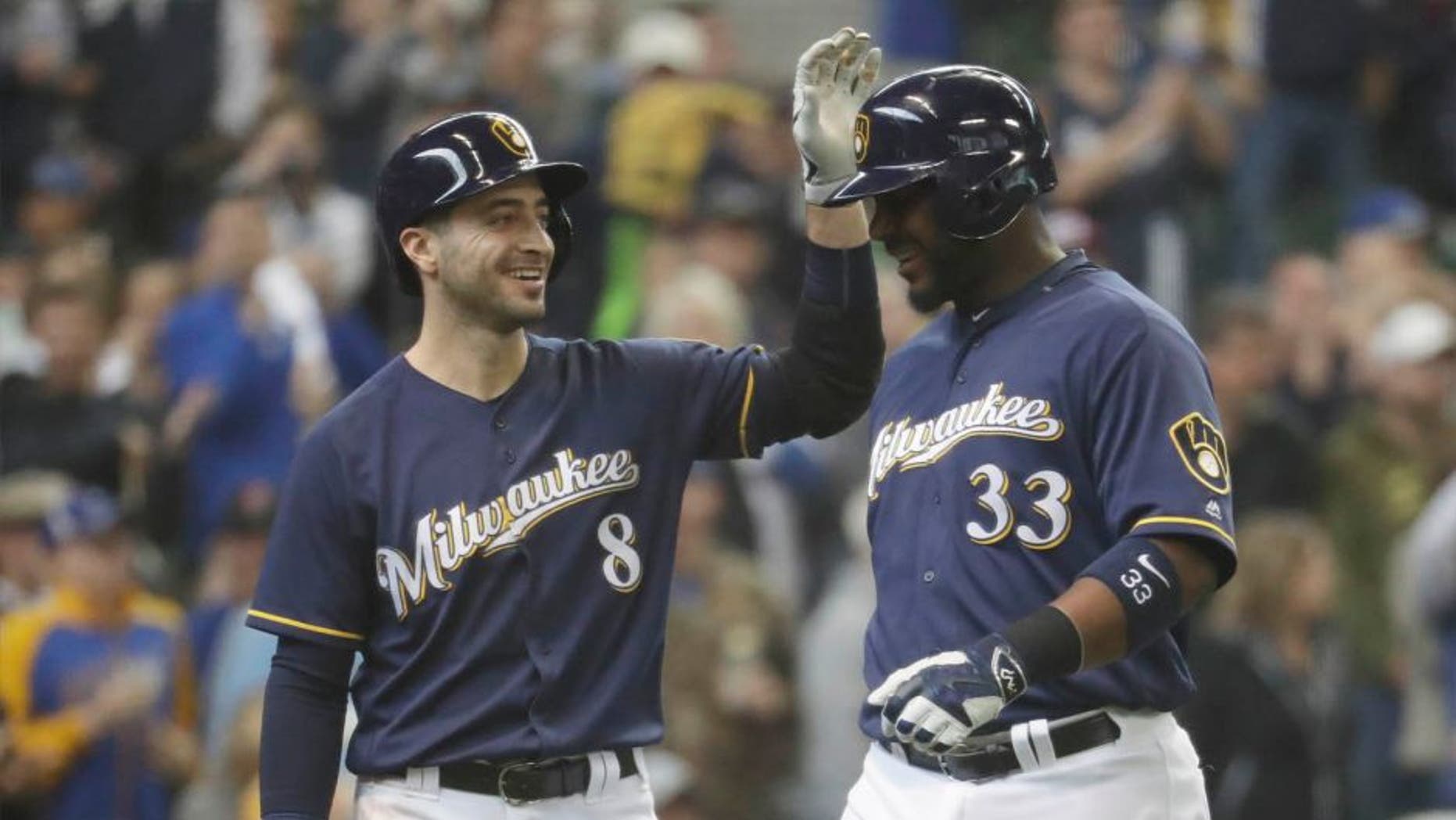 The Milwaukee Brewers' Chris Carter (right) is congratulated by Ryan Braun after hitting a two-run home run during the third inning against the Miami Marlins on Sunday, May 1, 2016, in Milwaukee.