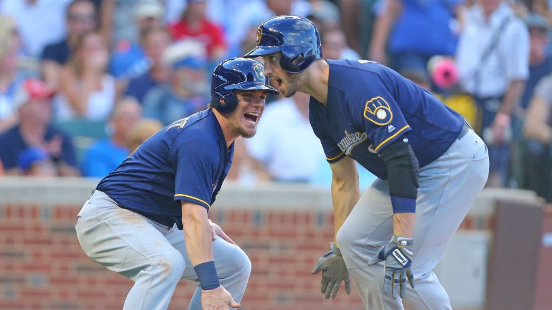 Milwaukee Brewers left fielder Ryan Braun celebrates his two RBI home run with second baseman Scooter Gennett during the sixth inning against the Chicago Cubs.