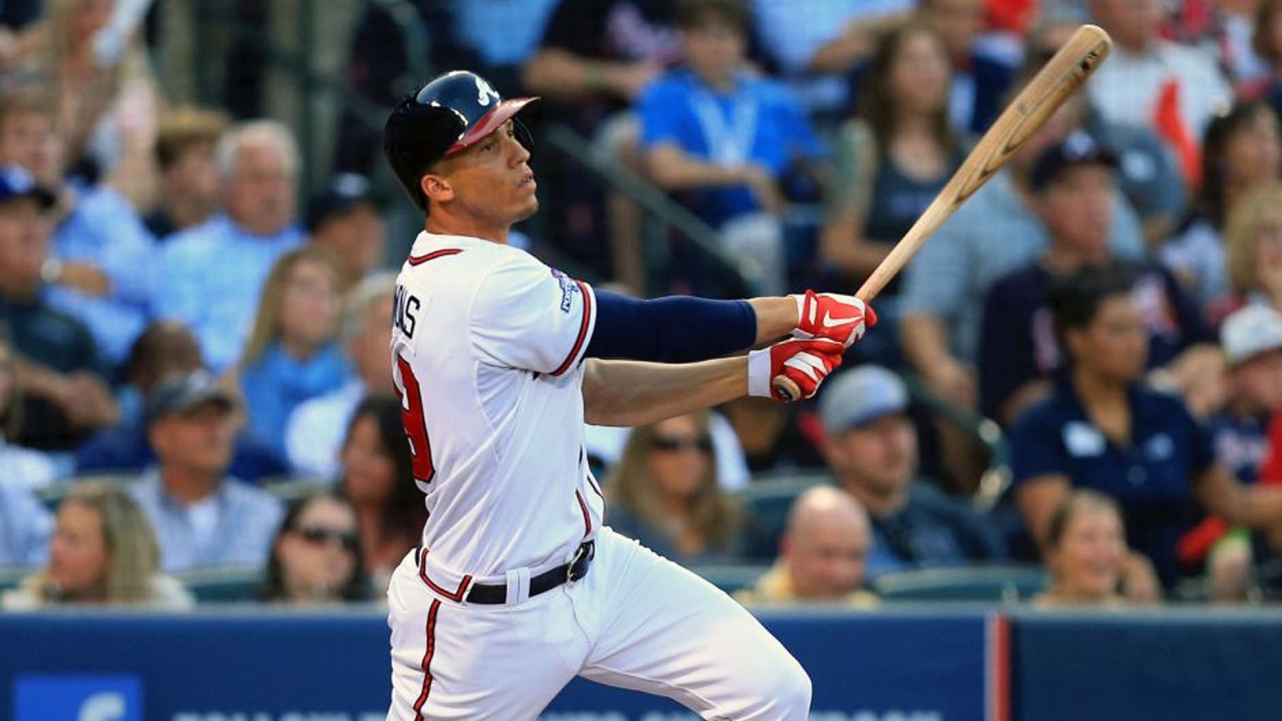 Oct 4, 2013; Atlanta, GA, USA; Atlanta Braves shortstop Andrelton Simmons (19) hits an RBI double against the Los Angeles Dodgers during the second inning of game two of the National League divisional series playoff baseball game at Turner Field. Mandatory Credit: Daniel Shirey-USA TODAY Sports