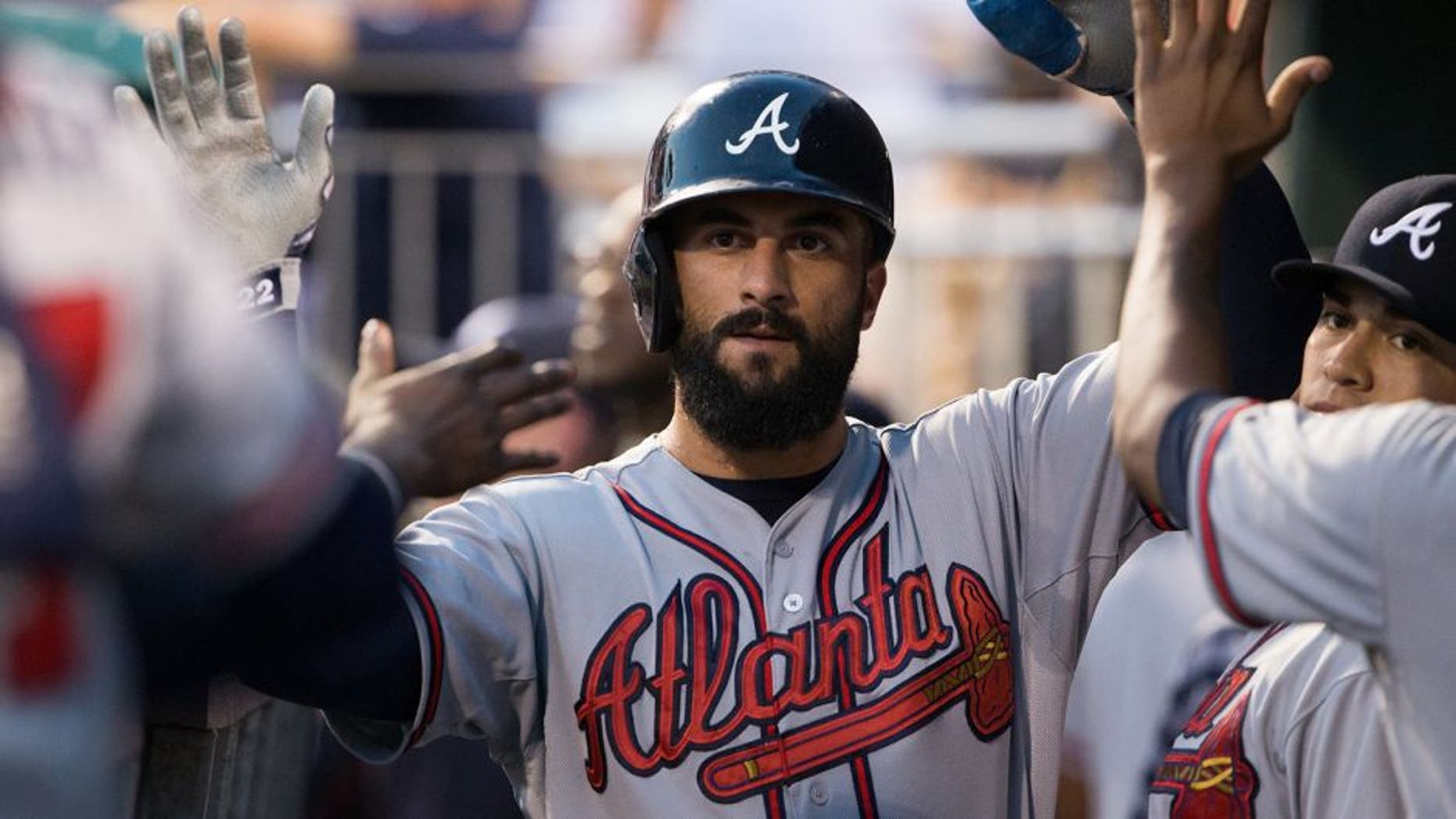 Sep 9, 2015; Philadelphia, PA, USA; Atlanta Braves right fielder Nick Markakis (22) celebrates in the dugout after scoring against the Philadelphia Phillies during the first inning at Citizens Bank Park. Mandatory Credit: Bill Streicher-USA TODAY Sports