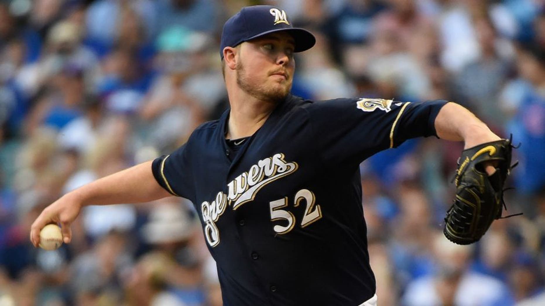 Jul 30, 2015; Milwaukee, WI, USA; Milwaukee Brewers pitcher Jimmy Nelson (52) pitches in the first inning against the Chicago Cubs at Miller Park. Mandatory Credit: Benny Sieu-USA TODAY Sports