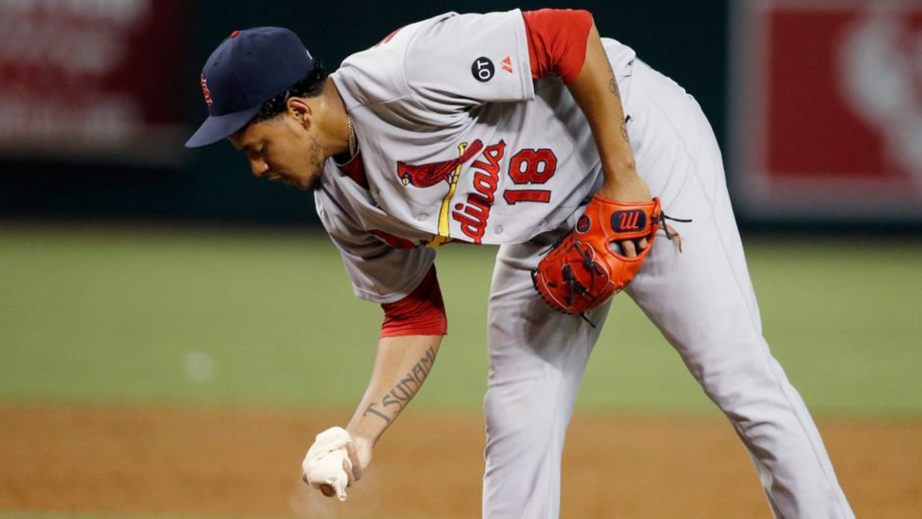 St. Louis Cardinals' Carlos Martinez grabs the rosin bag after giving up a two-run single to Arizona Diamondbacks' Ender Inciarte during the second inning of a baseball game Wednesday, Aug. 27, 2015, in Phoenix. (AP Photo/Ross D. Franklin)