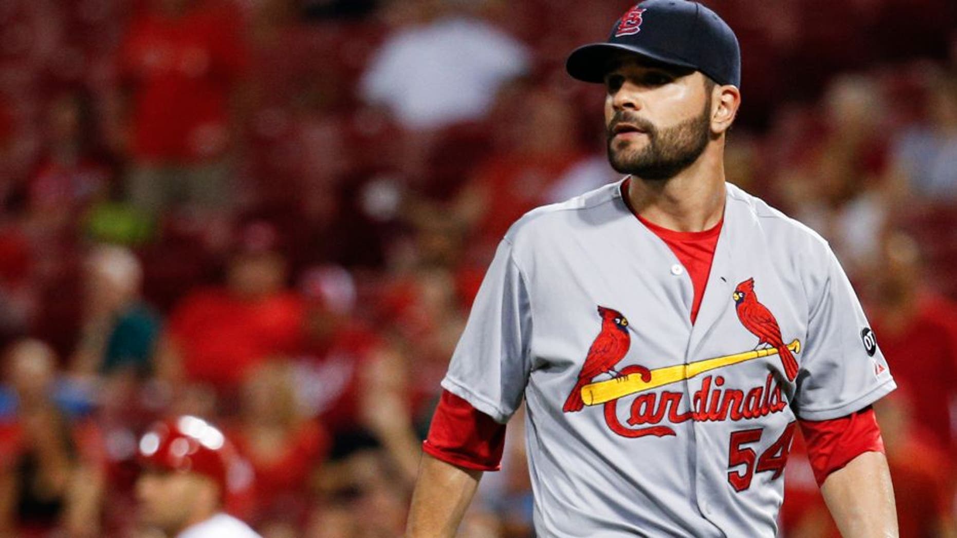 St. Louis Cardinals starting pitcher Jaime Garcia (54) watches an RBI-double hit by Cincinnati Reds' Joey Votto, left, in the fifth inning of a baseball game, Thursday, Sept. 10, 2015, in Cincinnati. (AP Photo/John Minchillo)