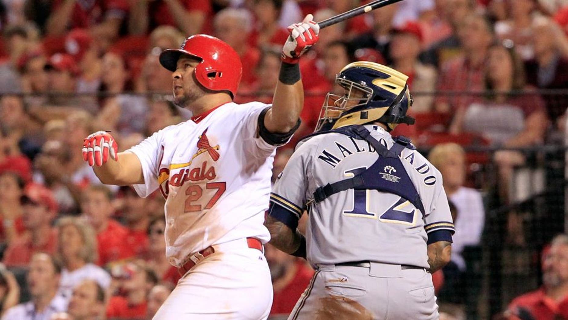 St. Louis Cardinals' Jhonny Peralta watches his three-run home run along side Milwaukee Brewers catcher Martin Maldonado during the fourth inning of a baseball game on Thursday, Sept. 24, 2015, in St. Louis. (AP Photo/Jeff Roberson)