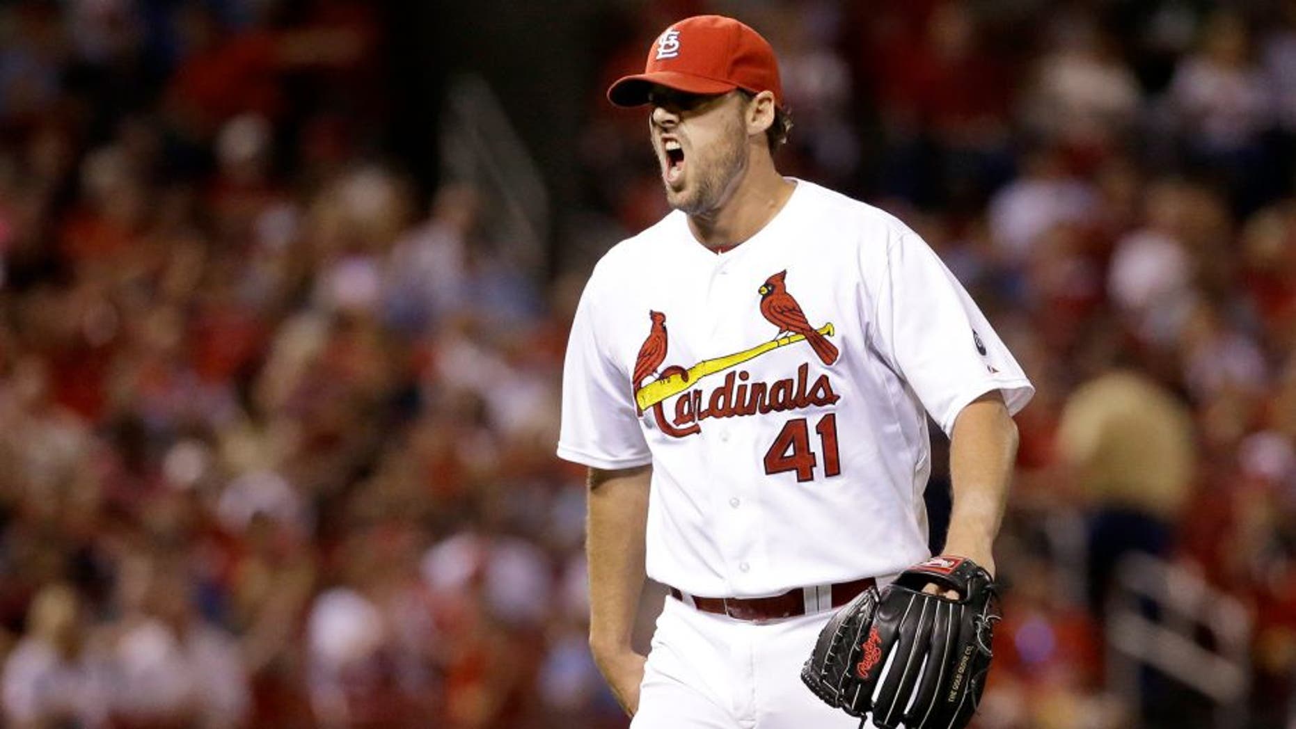 St. Louis Cardinals starting pitcher John Lackey yells as he walks off the field after getting Cincinnati Reds' Tucker Barnhart to line out to end the top of the seventh inning of a baseball game on Tuesday, Sept. 22, 2015, in St. Louis. (AP Photo/Jeff Roberson)