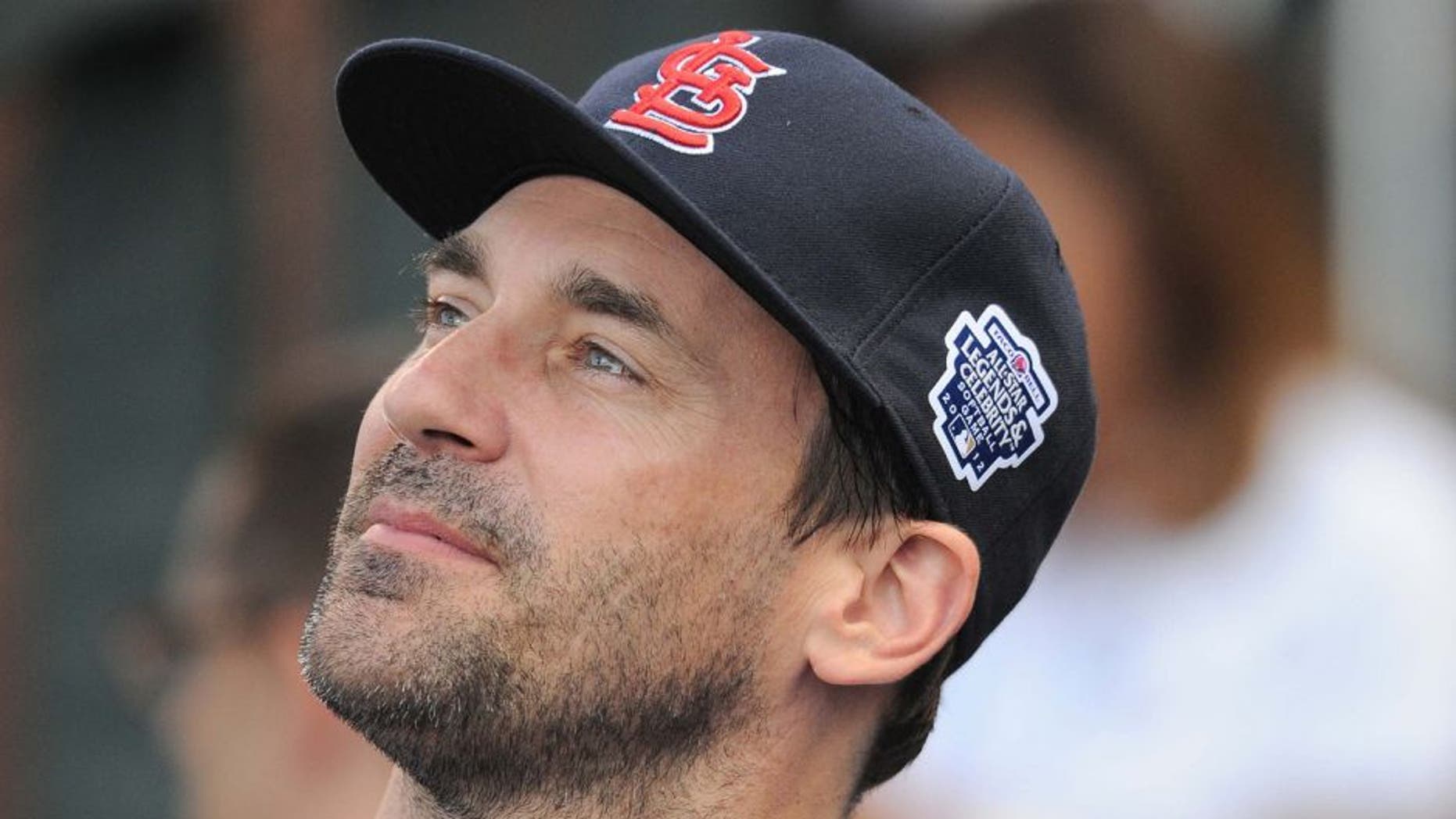 July 8, 2012; Kansas City, MO, USA; Television actor Jon Hamm relaxes in the dugout suite before the start of the 2012 Legends and Celebrity softball game at Kauffman Stadium. Mandatory Credit: Denny Medley-USA TODAY Sports