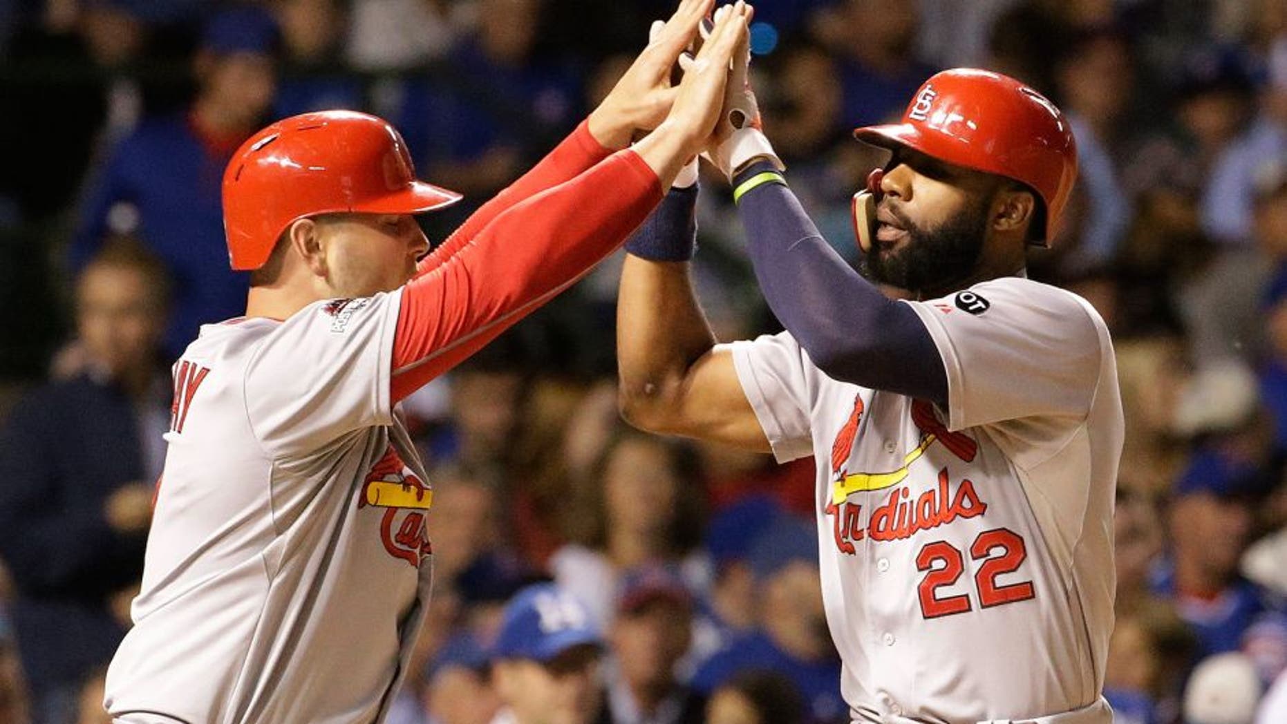 St. Louis Cardinals' Jason Heyward (22) celebrates with Matt Holliday (7) after hitting a home run against the Chicago Cubs during the sixth inning of Game 3 in baseball's National League Division Series, Monday, Oct. 12, 2015, in Chicago. (AP Photo/Nam Y. Huh)