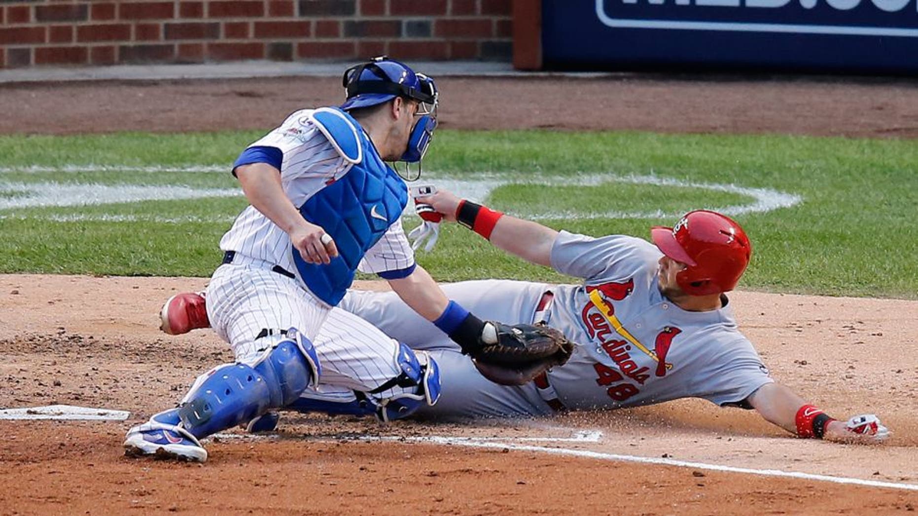 Chicago Cubs catcher Miguel Montero (47) tags out St. Louis Cardinals' Tony Cruz (48) during the sixth inning of Game 4 in baseball's National League Division Series, Tuesday, Oct. 13, 2015, in Chicago. (AP Photo/Charles Rex Arbogast)