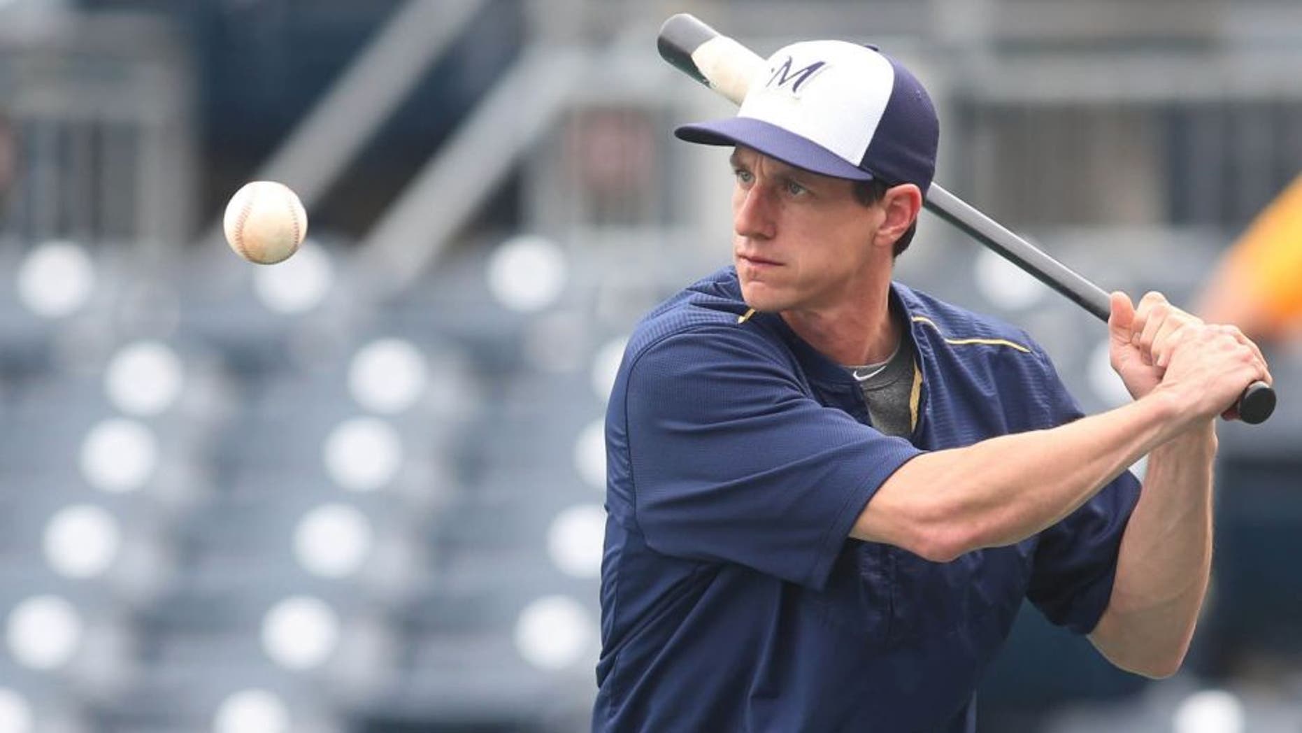 Jun 8, 2015; Pittsburgh, PA, USA; Milwaukee Brewers manager Craig Counsell hits during infield practice before the game against the Pittsburgh Pirates at PNC Park.