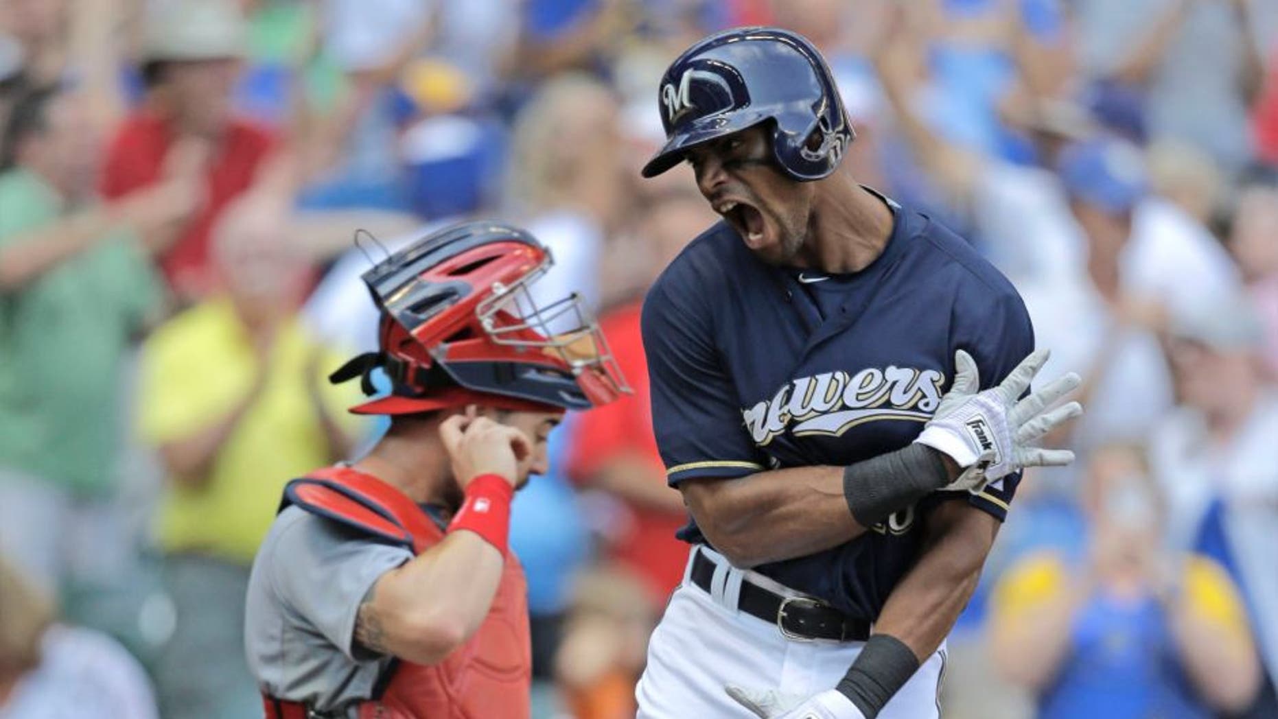 The Milwaukee Brewers' Khris Davis crosses the plate after his two-run home run against the St. Louis Cardinals in the eighth inning Sunday, Aug. 9, 2015, in Milwaukee.