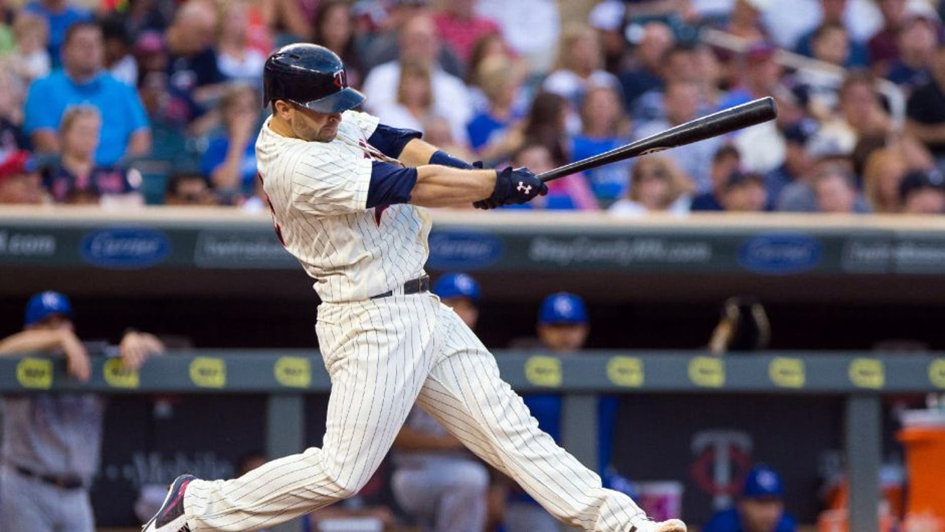 Minnesota Twins second baseman Brian Dozier hits his 100th career home run in the sixth inning against the Kansas City Royals on Saturday, Aug. 12, 2016, in Minneapolis.