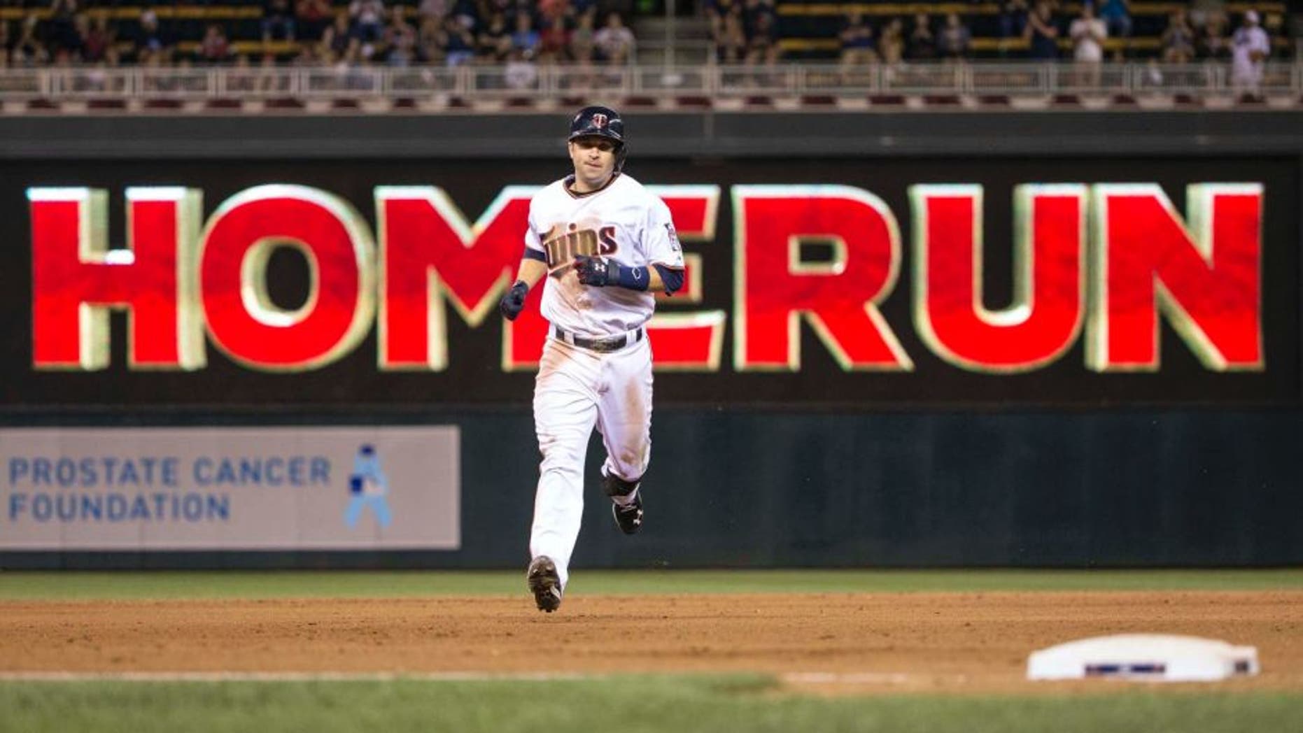 Jun 22, 2015; Minneapolis, MN, USA; Minnesota Twins second baseman Brian Dozier rounds second base after hitting a home run in the eighth inning against the Chicago White Sox at Target Field.
