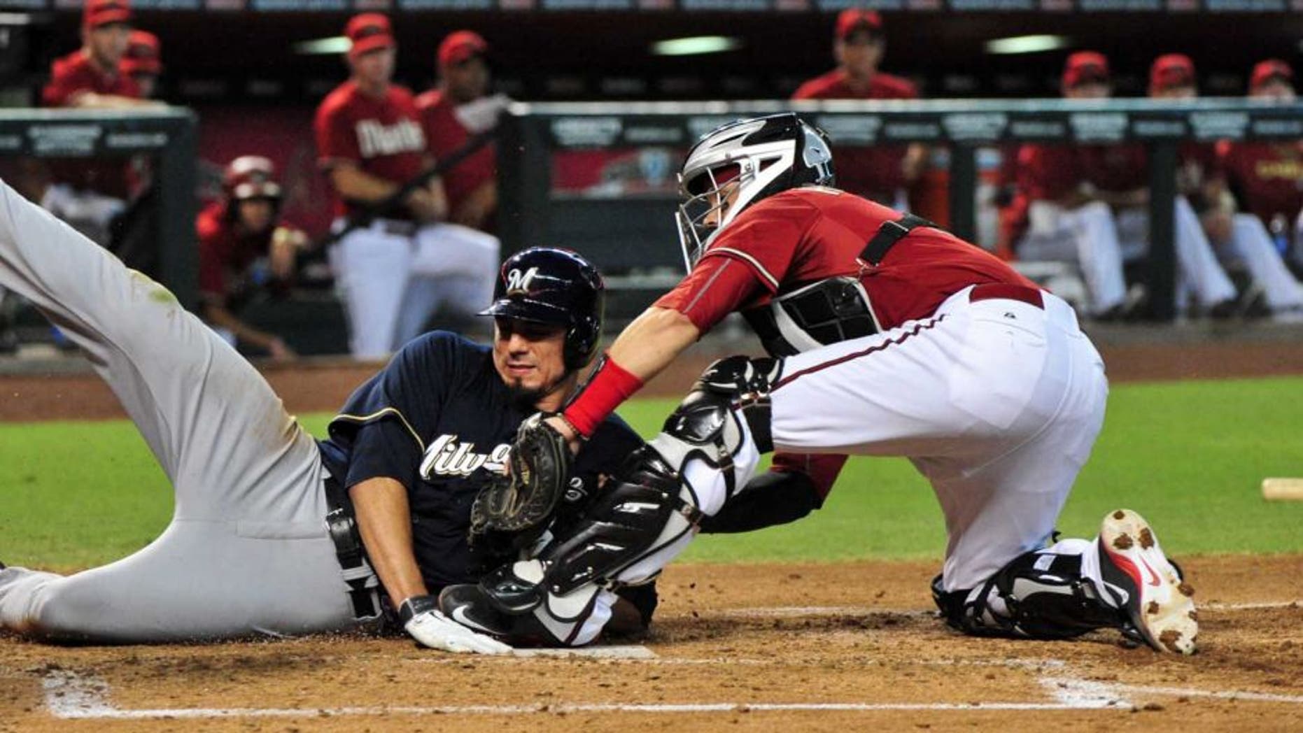 Jul 26, 2015; Phoenix, AZ, USA; Arizona Diamondbacks catcher Oscar Hernandez (right) tags out Milwaukee Brewers starting pitcher Matt Garza during the third inning at Chase Field.
