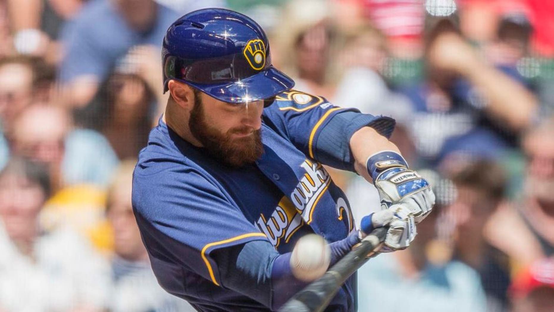 The Milwaukee Brewers' Jonathan Lucroy connects for a sacrifice fly to right off the Cincinnati Reds' Brandon Finnegan during the first inning Sunday, May 29, 2016, in Milwaukee.