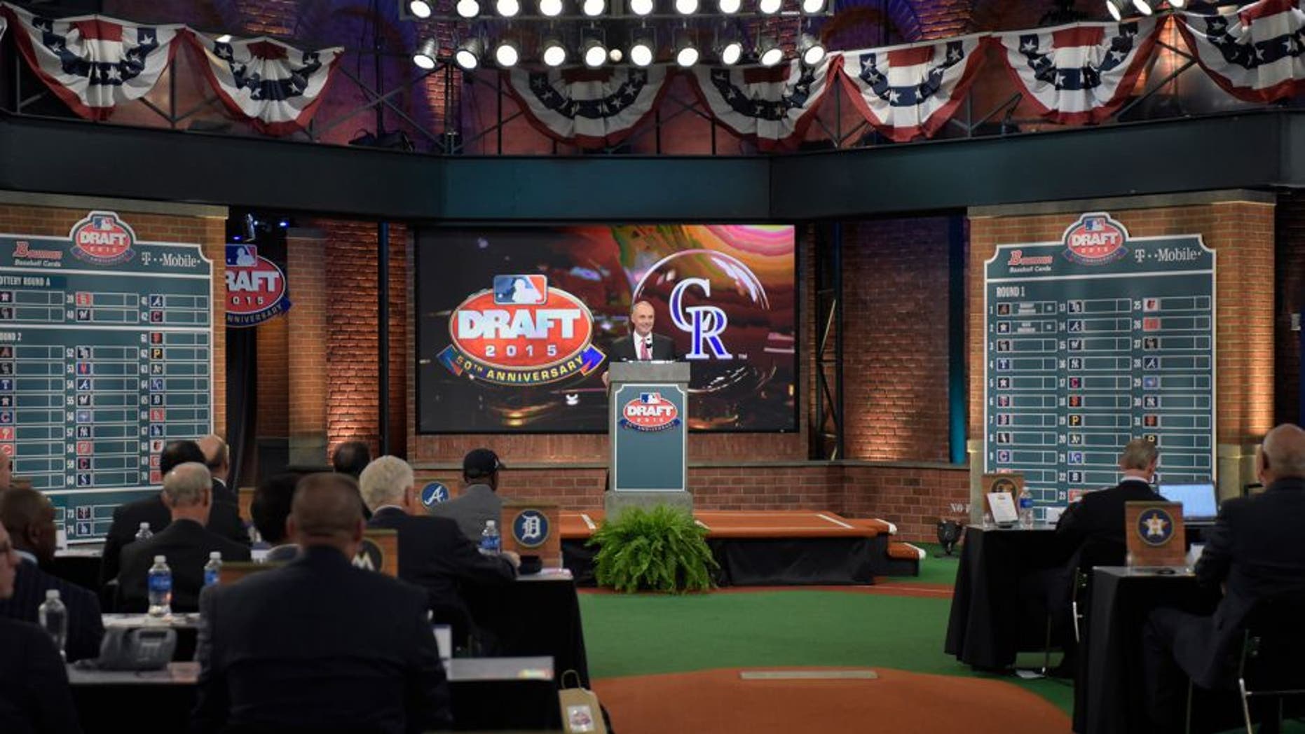 Commissioner of Major League Baseball Rob Manfred announces the third selection at the 2015 MLB baseball draft Monday, June 8, 2015, in Secaucus, N.J. Brendan Rodgers was chosen by the Colorado Rockies with the third selection. (AP Photo/Bill Kostroun)