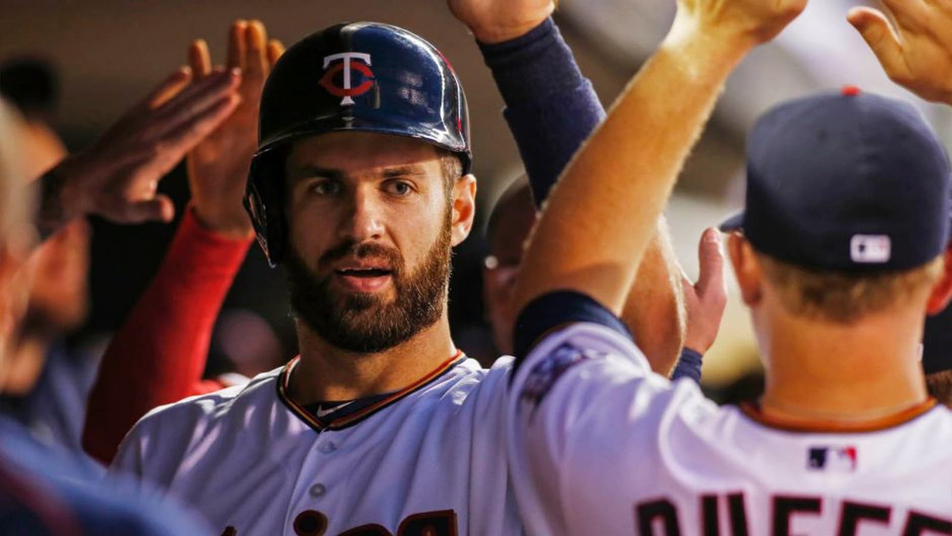 Minnesota Twins first baseman Joe Mauer celebrates his run against the Detroit Tigers in the first inning of a baseball game, Monday, Sept. 14, 2015, in Minneapolis.