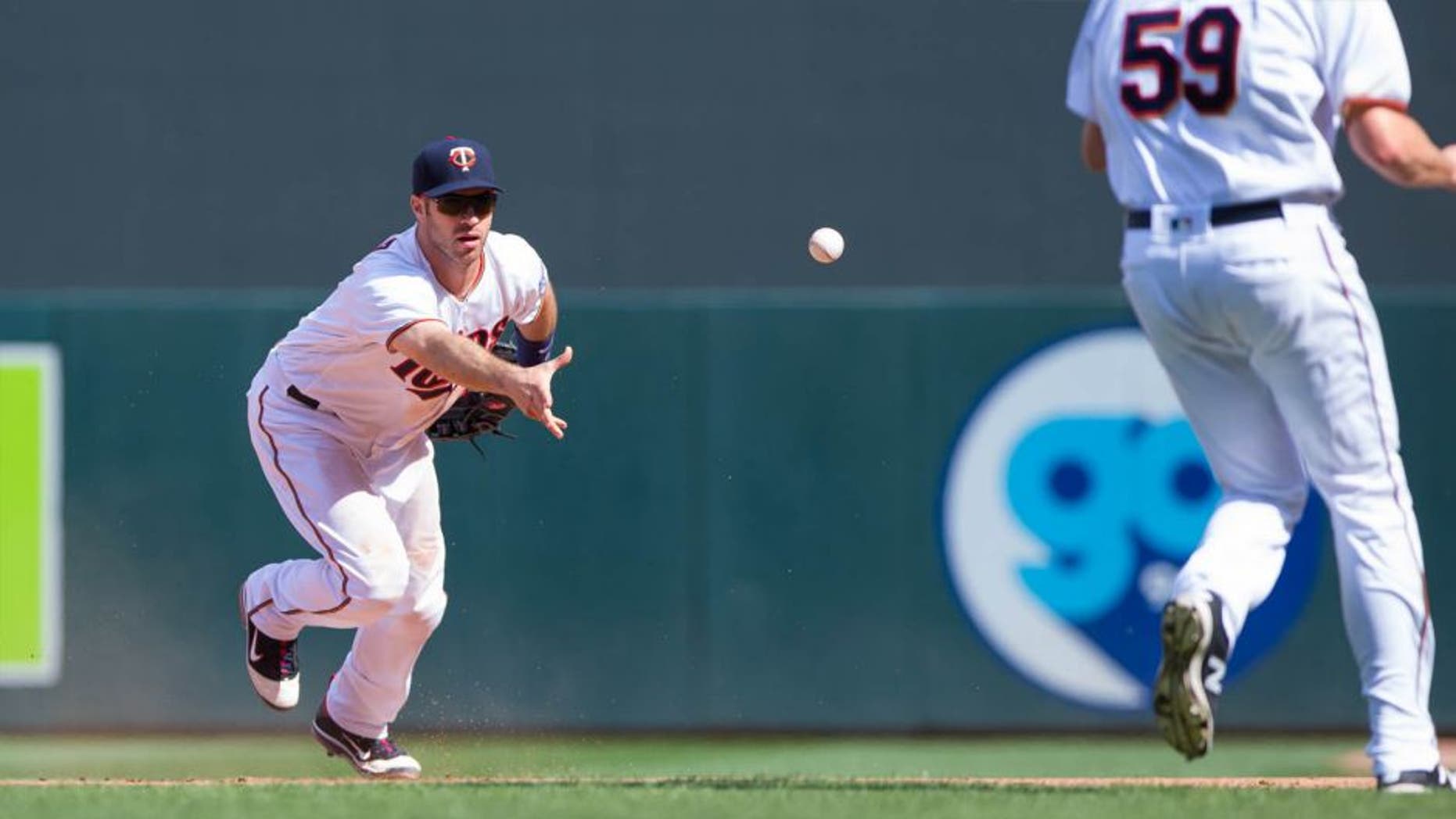 Minnesota Twins first baseman Joe Mauer (left) tosses the ball to relief pitcher Michael Tonkin for an out in the 10th inning against the Boston Red Sox at Target Field in Minneapolis on June 12, 2016. The Twins won 7-4 in 10 innings.