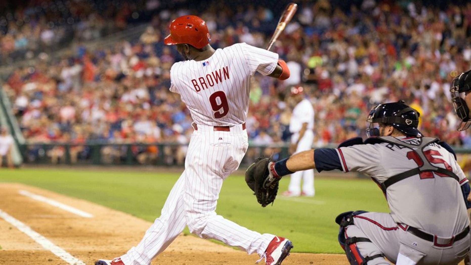 Jul 31, 2015; Philadelphia, PA, USA; Philadelphia Phillies right fielder Domonic Brown (9) hits a two RBI home run during the fifth inning against the Atlanta Braves at Citizens Bank Park. Mandatory Credit: Bill Streicher-USA TODAY Sports