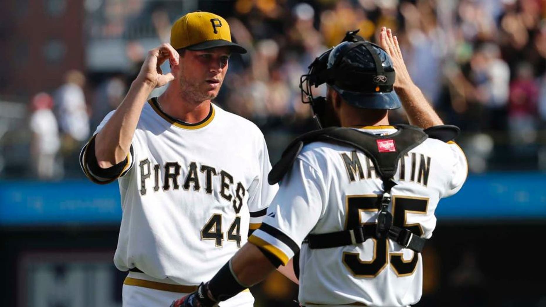 Sunday, September 21: Pittsburgh Pirates relief pitcher Tony Watson (left) celebrates with catcher Russell Martin after getting the final out of the ninth inning. The Pirates won 1-0.