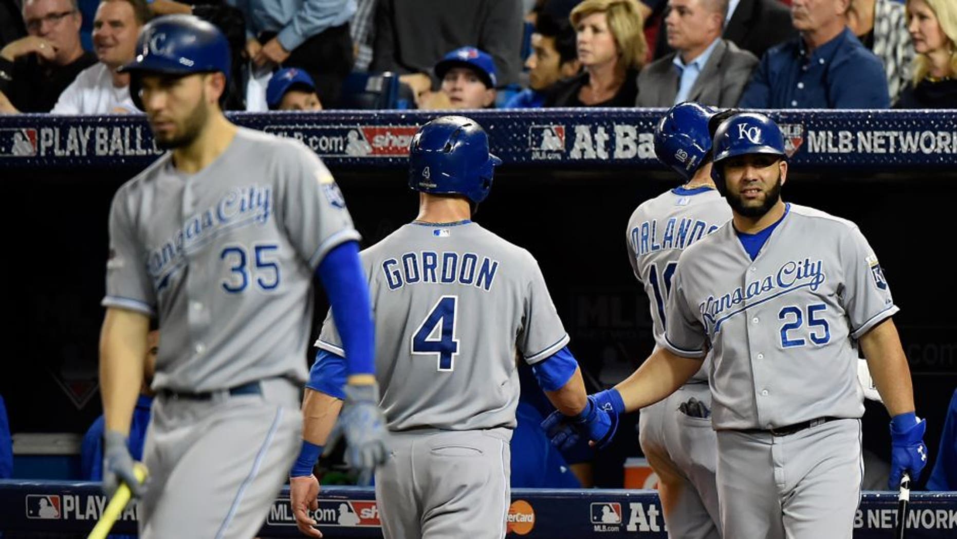 Oct 20, 2015; Toronto, Ontario, CAN; Kansas City Royals left fielder Alex Gordon (4) celebrates with designated hitter Kendrys Morales (25) after scoring during the game against the Toronto Blue Jays in game four of the ALCS at Rogers Centre. Mandatory Credit: Dan Hamilton-USA TODAY Sports