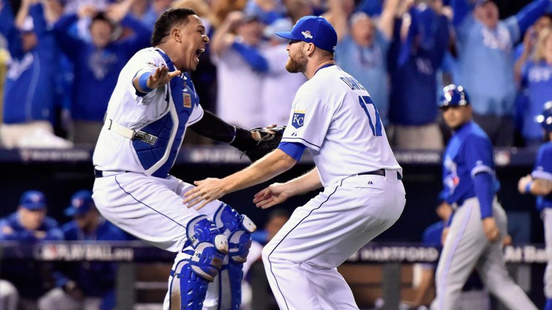 Kansas City Royals catcher Salvador Perez, left, and relief pitcher Wade Davis celebrate after defeating the Toronto Blue Jays in Game 6 of baseball's American League Championship Series on Friday, Oct. 23, 2015, in Kansas City, Mo. The Royals won 4-3. (Nathan Denette/The Canadian Press via AP) MANDATORY CREDIT