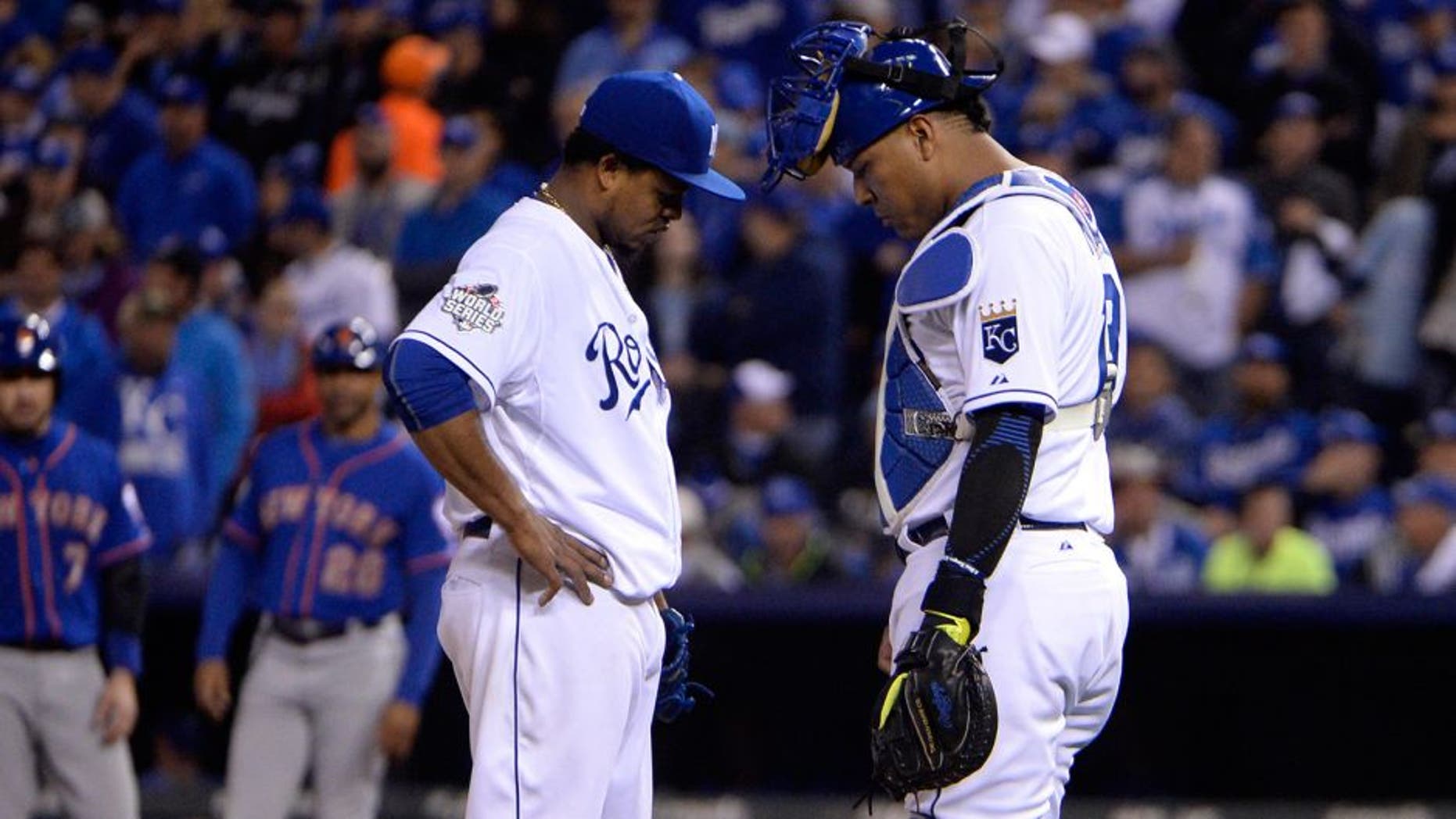 Oct 27, 2015; Kansas City, MO, USA; Kansas City Royals starting pitcher Edinson Volquez (left) talks with catcher Salvador Perez (right) in the fourth inning in game one of the 2015 World Series at Kauffman Stadium. Mandatory Credit: John Rieger-USA TODAY Sports