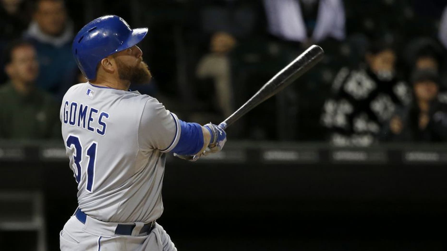 RETRANSMISSION TO CORRECT NAME OF PLAYER SCORING TO SALVADOR PEREZ FROM CHESLOR CUTHBERT - Kansas City Royals' Jonny Gomes watches his sacrifice fly off Chicago White Sox starting pitcher John Danks, scoring pinch runner Salvador Perez, during the fifth inning of a baseball game Thursday, Oct. 1, 2015, in Chicago. (AP Photo/Charles Rex Arbogast)