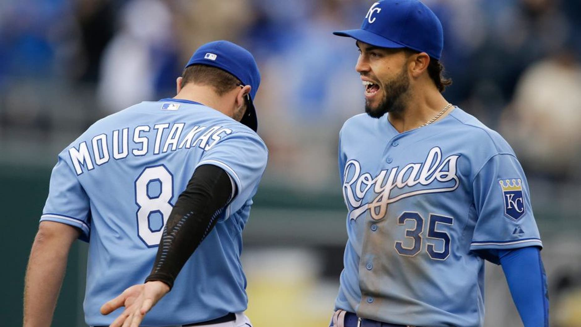 Kansas City Royals first baseman Eric Hosmer (35) and third baseman Mike Moustakas (8) celebrate following a baseball game against the Chicago White Sox at Kauffman Stadium in Kansas City, Mo., Thursday, April 9, 2015. The Royals defeated the White Sox 4-1. (AP Photo/Orlin Wagner)