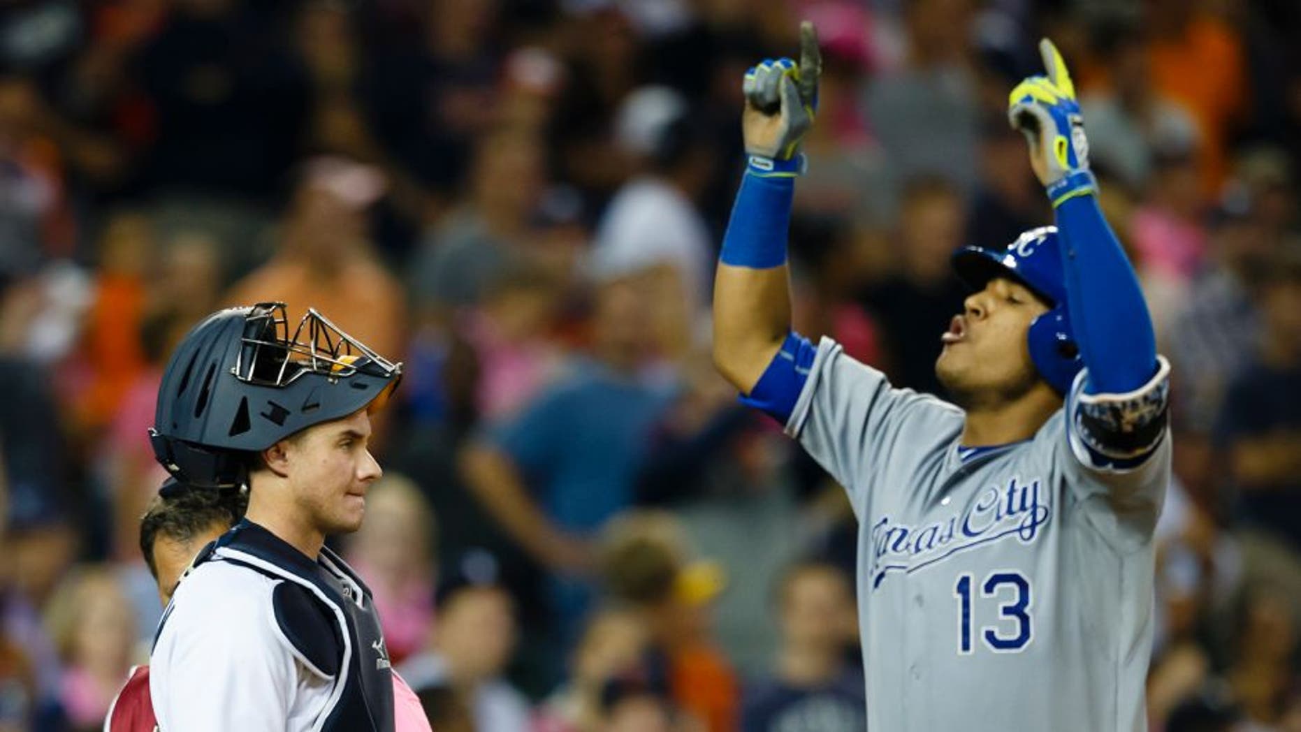Sep 18, 2015; Detroit, MI, USA; Detroit Tigers catcher James McCann (34) reacts as Kansas City Royals catcher Salvador Perez (13) celebrates his two run home run in the ninth inning at Comerica Park. Mandatory Credit: Rick Osentoski-USA TODAY Sports