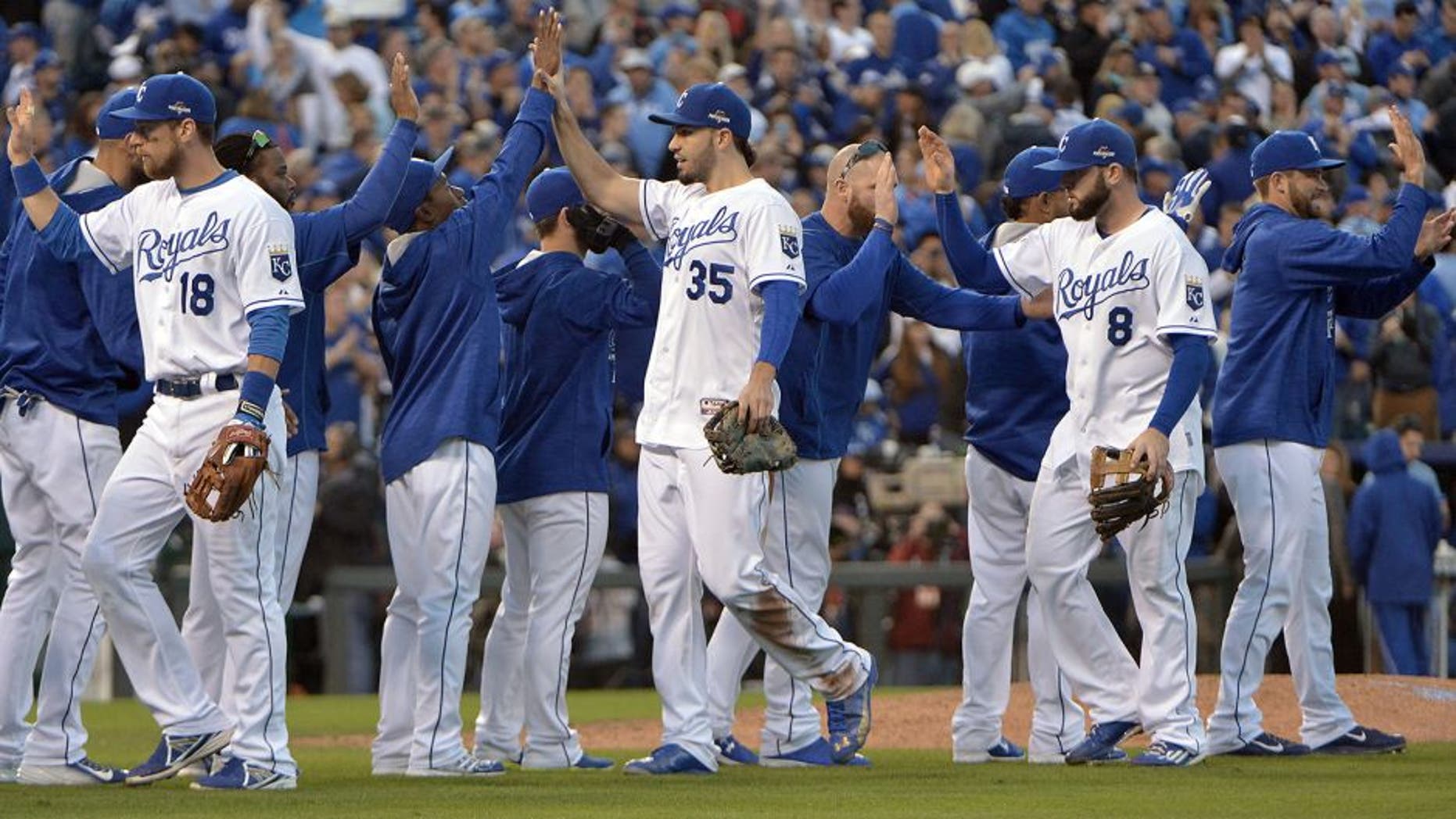 Oct 17, 2015; Kansas City, MO, USA; Kansas City Royals first baseman Eric Hosmer (35) celebrates with teammate after beating the Toronto Blue Jays in game two of the ALCS at Kauffman Stadium. Mandatory Credit: Denny Medley-USA TODAY Sports