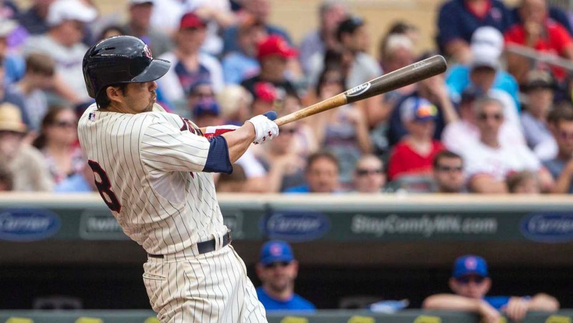 Jun 20, 2015; Minneapolis, MN, USA; Minnesota Twins catcher Kurt Suzuki hits a home run in the second inning against the Chicago Cubs at Target Field.