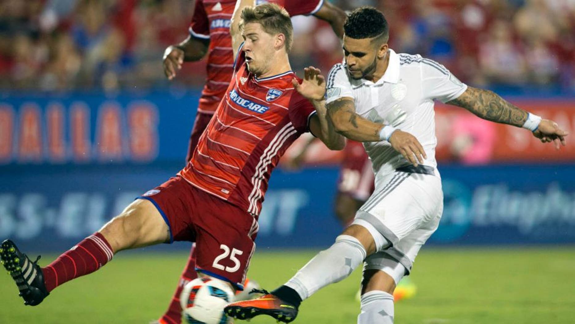 Aug 13, 2016; Dallas, TX, USA; Sporting Kansas City forward Dom Dwyer (14) scores his second goal while defended by FC Dallas defender Walker Zimmerman (25) in the second half at Toyota Stadium. FC Dallas and Sporting Kansas City tied 2-2. Mandatory Credit: Tim Heitman-USA TODAY Sports