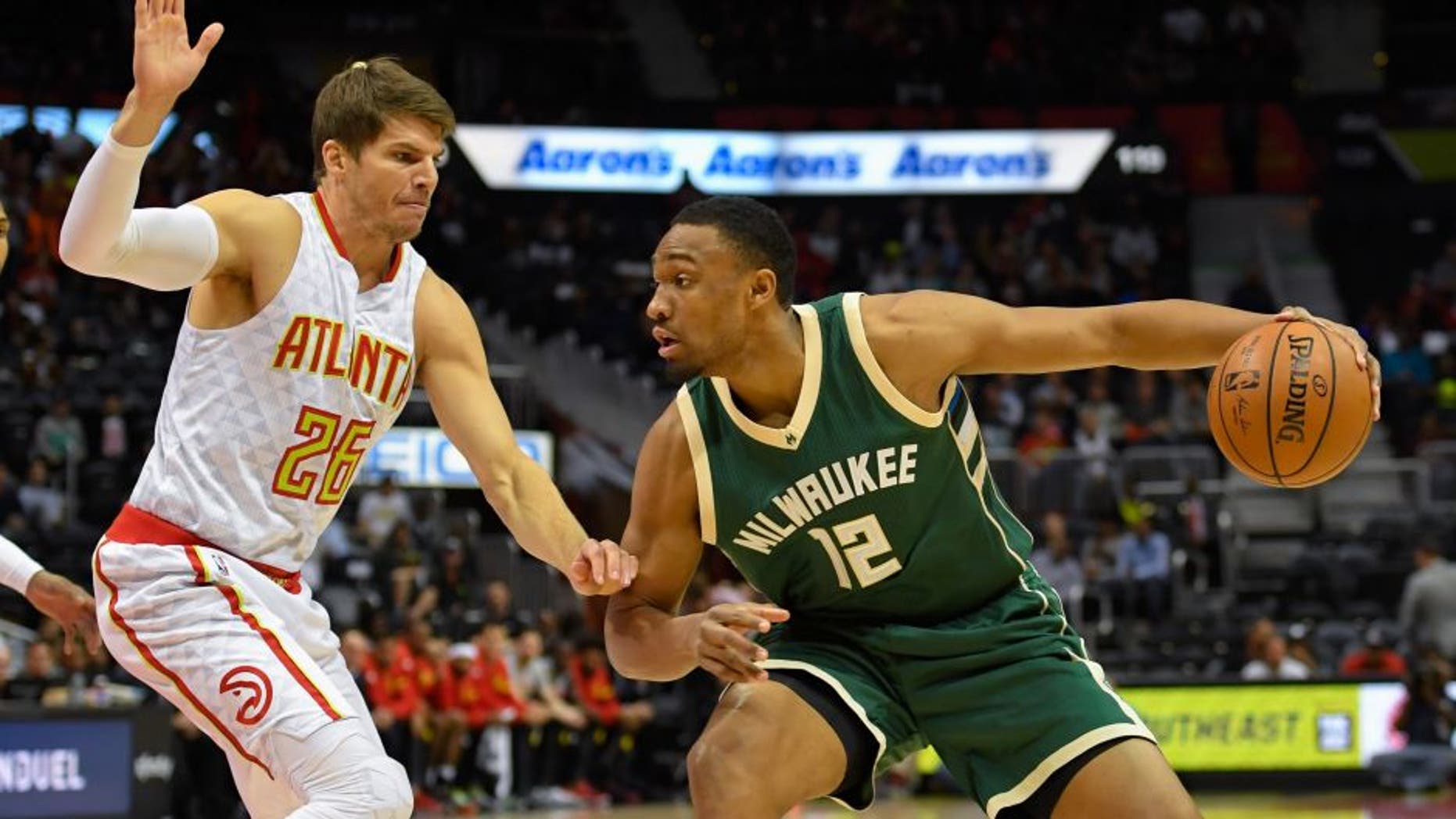 Nov 16, 2016; Atlanta, GA, USA; Milwaukee Bucks forward Jabari Parker (12) dribbles the ball in front of Atlanta Hawks guard Kyle Korver (26) during the first half at Philips Arena. Mandatory Credit: Dale Zanine-USA TODAY Sports