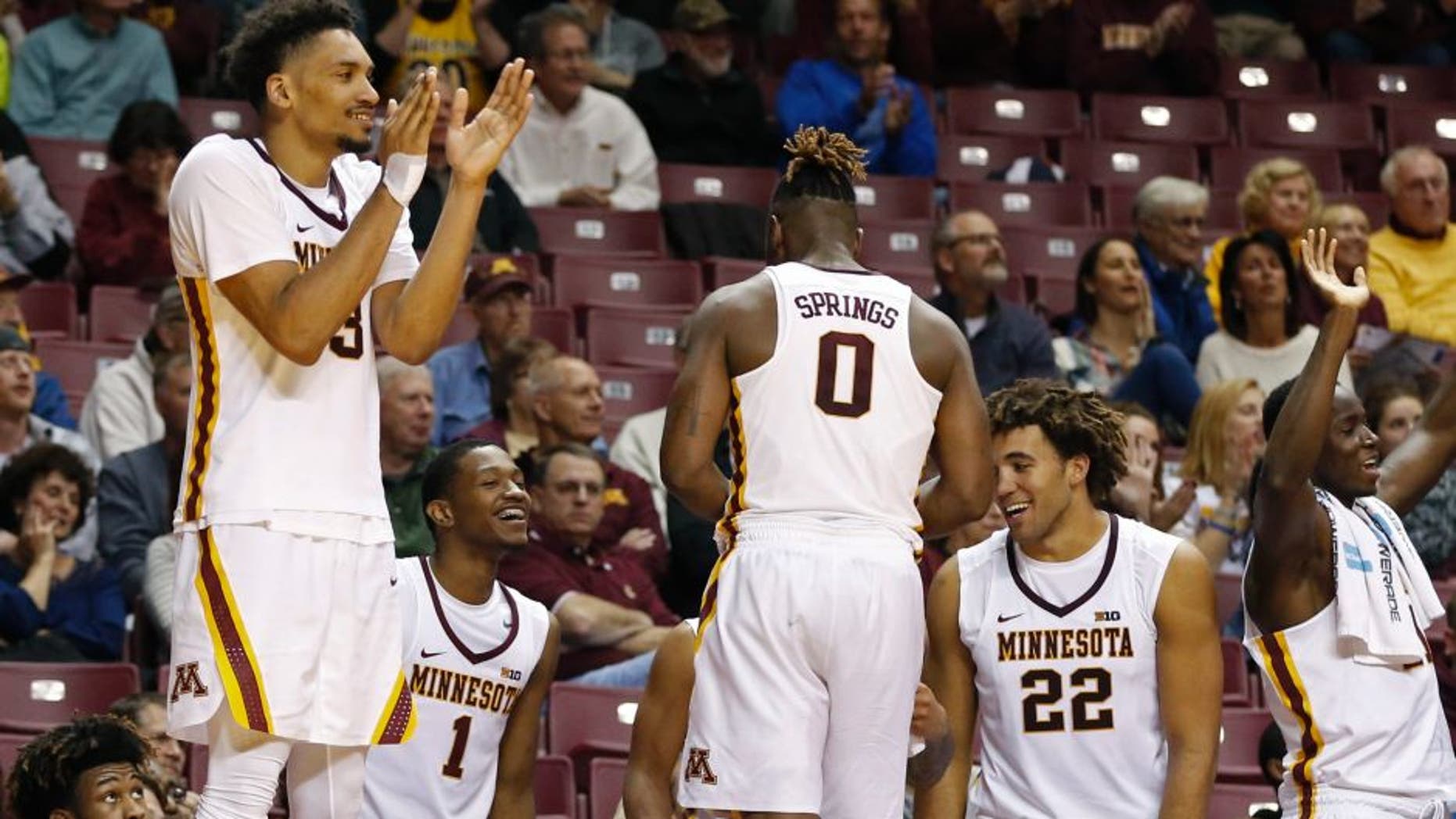 Minnesota's Jordan Murphy, left, applauded bench players as teammates celebrated the final moments of their team's 80-56 win over Mount St. Mary's in an NCAA college basketball game Wednesday, Nov. 16, 2016, in Minneapolis. Murphy led Minnesota with 18 points. (AP Photo/Jim Mone)