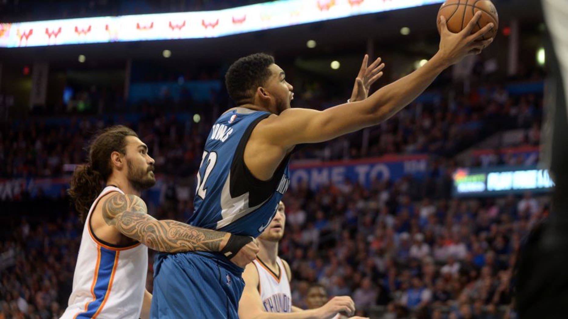 Nov 5, 2016; Oklahoma City, OK, USA; Oklahoma City Thunder center Steven Adams (12) fouls Minnesota Timberwolves center Karl-Anthony Towns (32) during the second quarter at Chesapeake Energy Arena. Mandatory Credit: Mark D. Smith-USA TODAY Sports