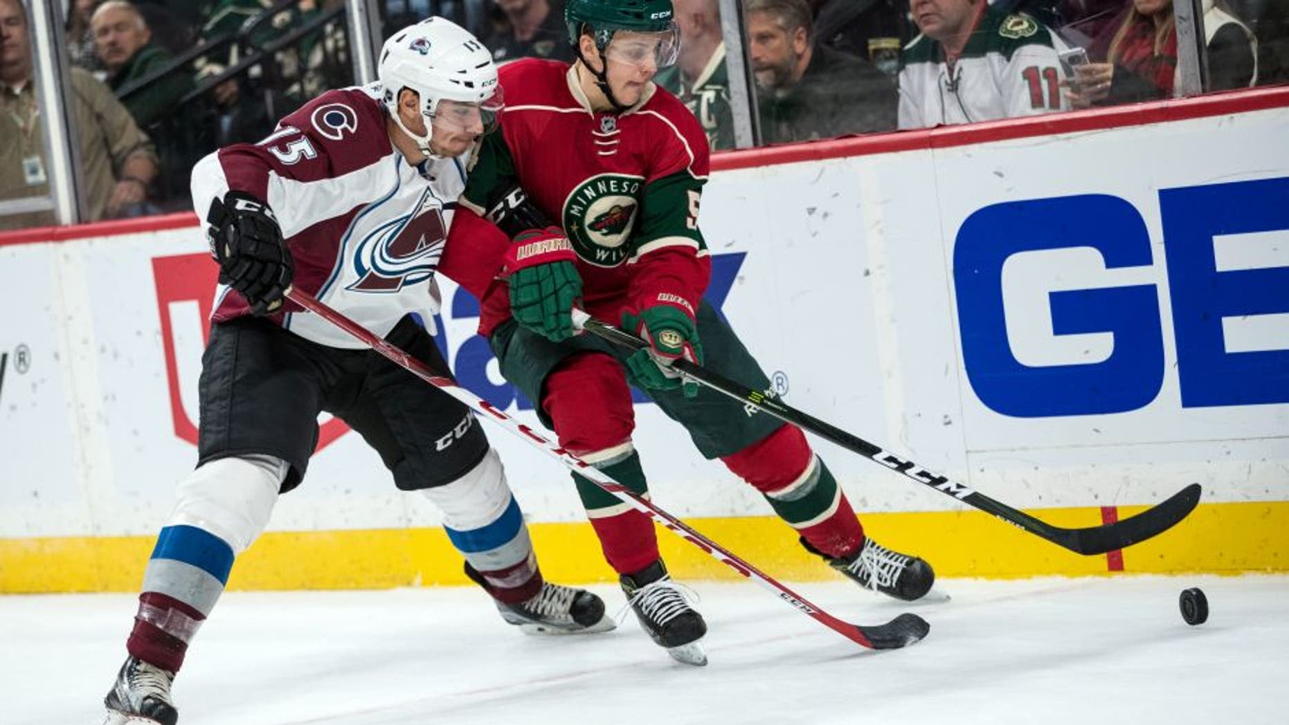 Sep 27, 2016; Saint Paul, MN, USA; Minnesota Wild forward Joel Eriksson Ek (54) protects the puck from Colorado Avalanche defenseman Duncan Siemens (15) during the second period of a preseason hockey game at Xcel Energy Center. Mandatory Credit: Brace Hemmelgarn-USA TODAY Sports