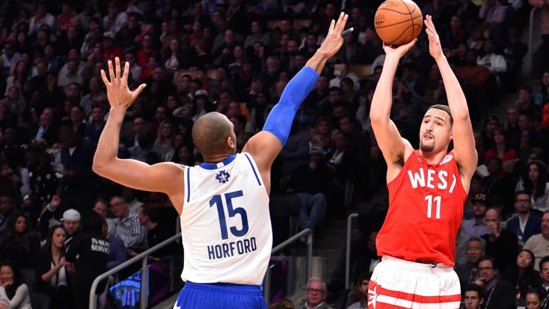 Feb 14, 2016; Toronto, Ontario, CAN; Western Conference guard Klay Thompson of the Golden State Warriors (11) shoots against Eastern Conference player Al Horford (15) of the Atlanta Hawks in the first half of the NBA All Star Game at Air Canada Centre. Mandatory Credit: Bob Donnan-USA TODAY Sports