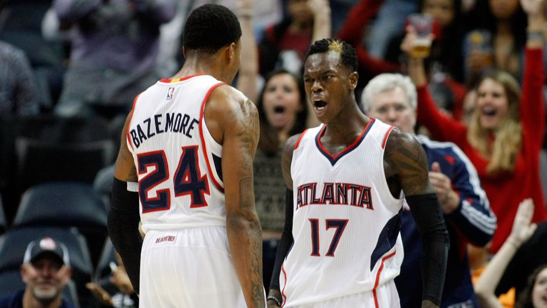 Dec 2, 2014; Atlanta, GA, USA; Atlanta Hawks guard Kent Bazemore (24) and guard Dennis Schroder (17) celebrate after a made basket against the Boston Celtics in the fourth quarter at Philips Arena. The Hawks defeated the Celtics 109-105. Mandatory Credit: Brett Davis-USA TODAY Sports