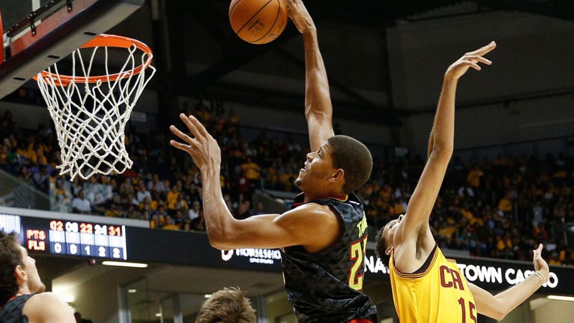 Atlanta Hawks center Walter Tavares (22) shoots over Cleveland Cavaliers forward Austin Daye (15) in the second half of an NBA preseason basketball game, Wednesday, Oct. 7, 2015, in Cincinnati. The Hawks won 98-96. (AP Photo/John Minchillo)