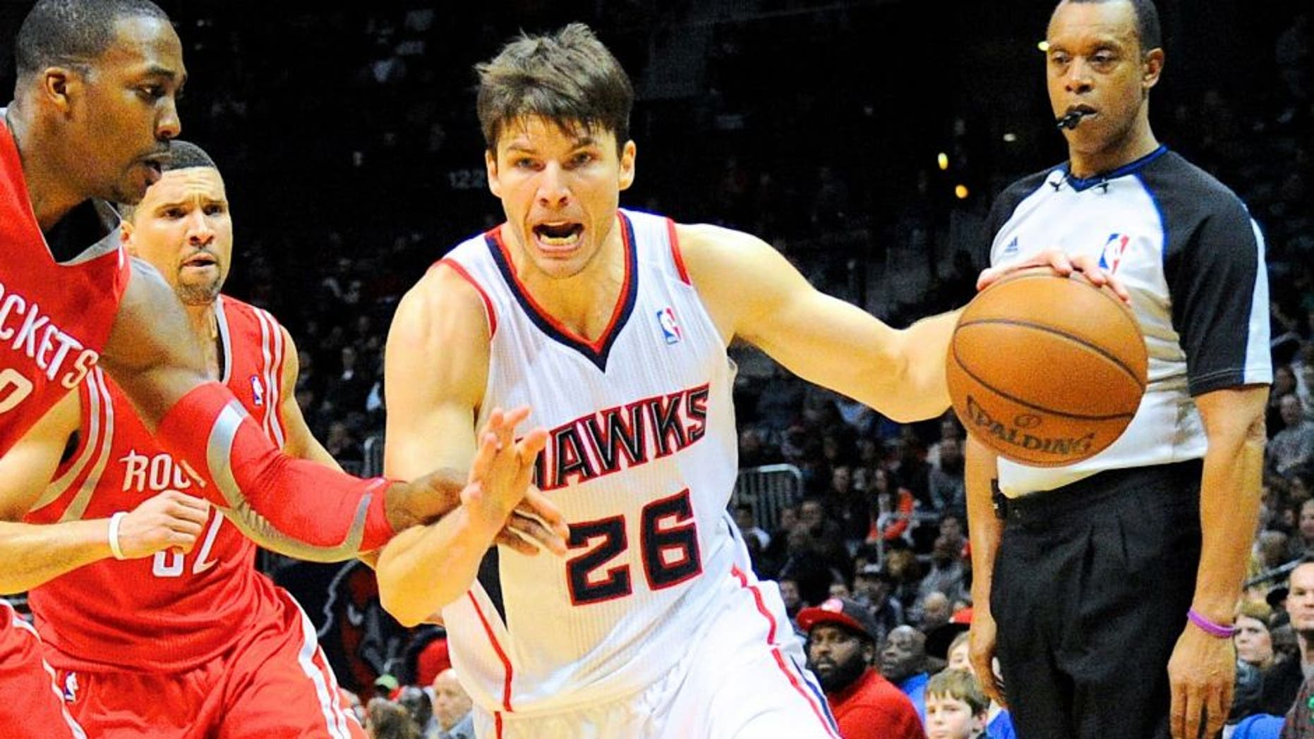 Jan 10, 2014; Atlanta, GA, USA; Atlanta Hawks shooting guard Kyle Korver (26) tries to get past Houston Rockets power forward Dwight Howard (12) during the second half at Philips Arena. The Hawks defeated the Rockets 83-80. Mandatory Credit: Dale Zanine-USA TODAY Sports